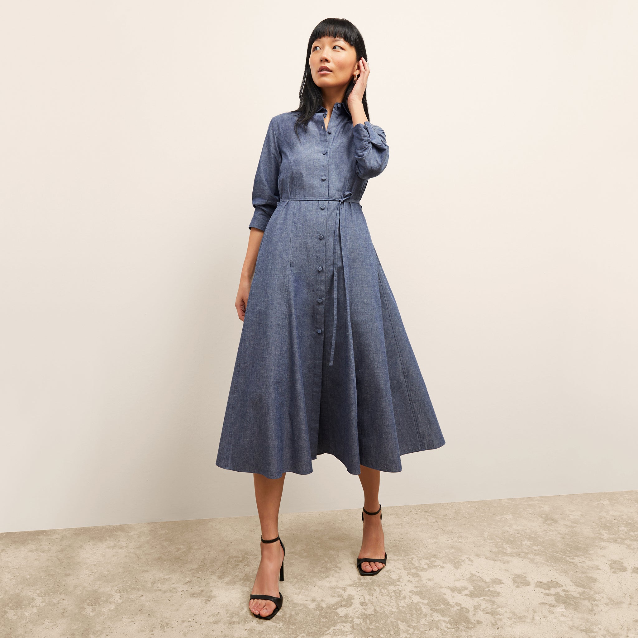front image of a woman wearing the pepper dress in clear blue