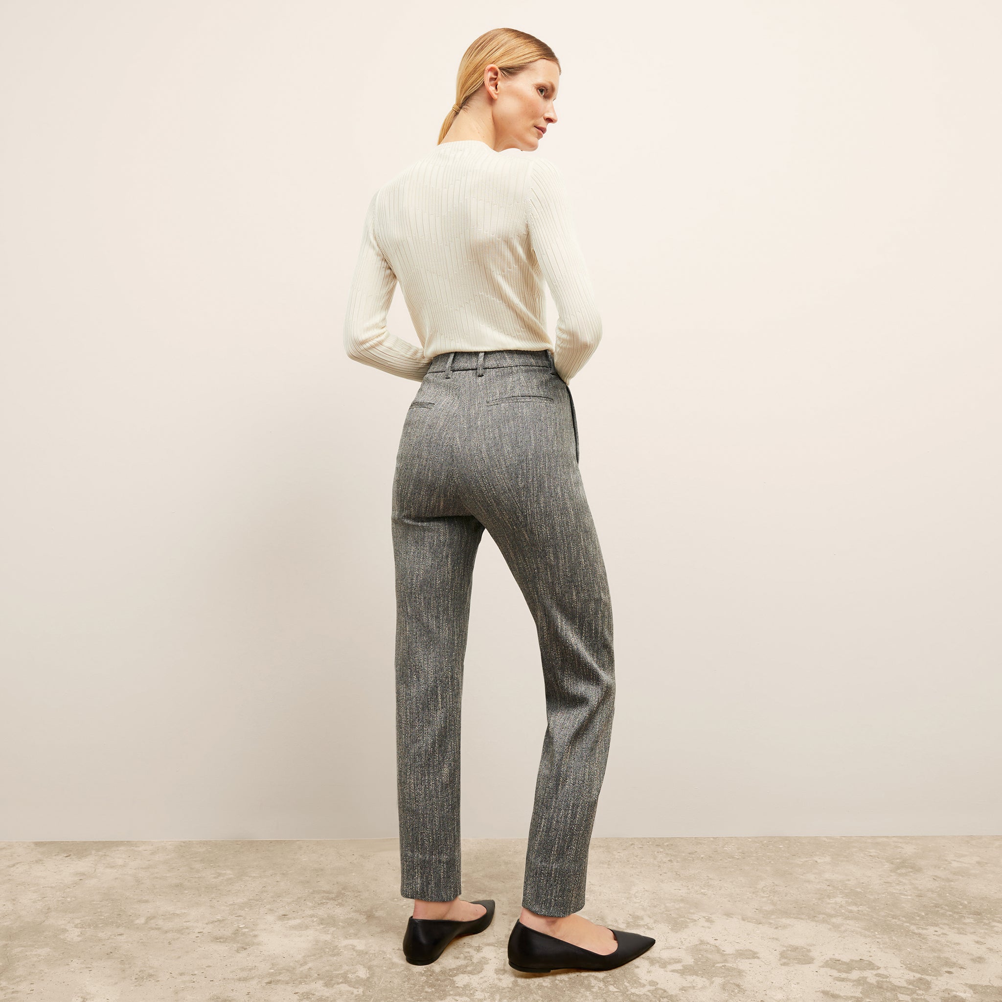 back image of a woman wearing the pearl pant in black/ivory