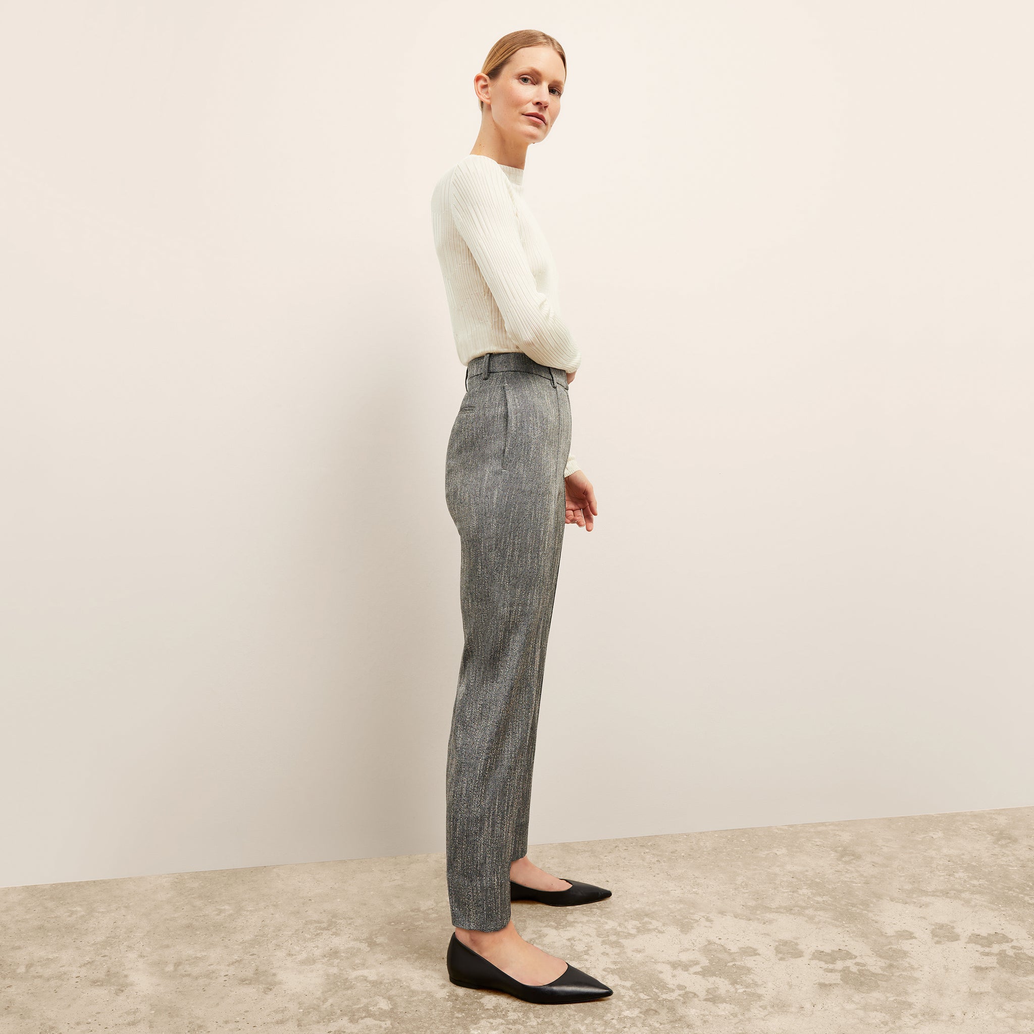 side image of a woman wearing the pearl pant in black/ivory