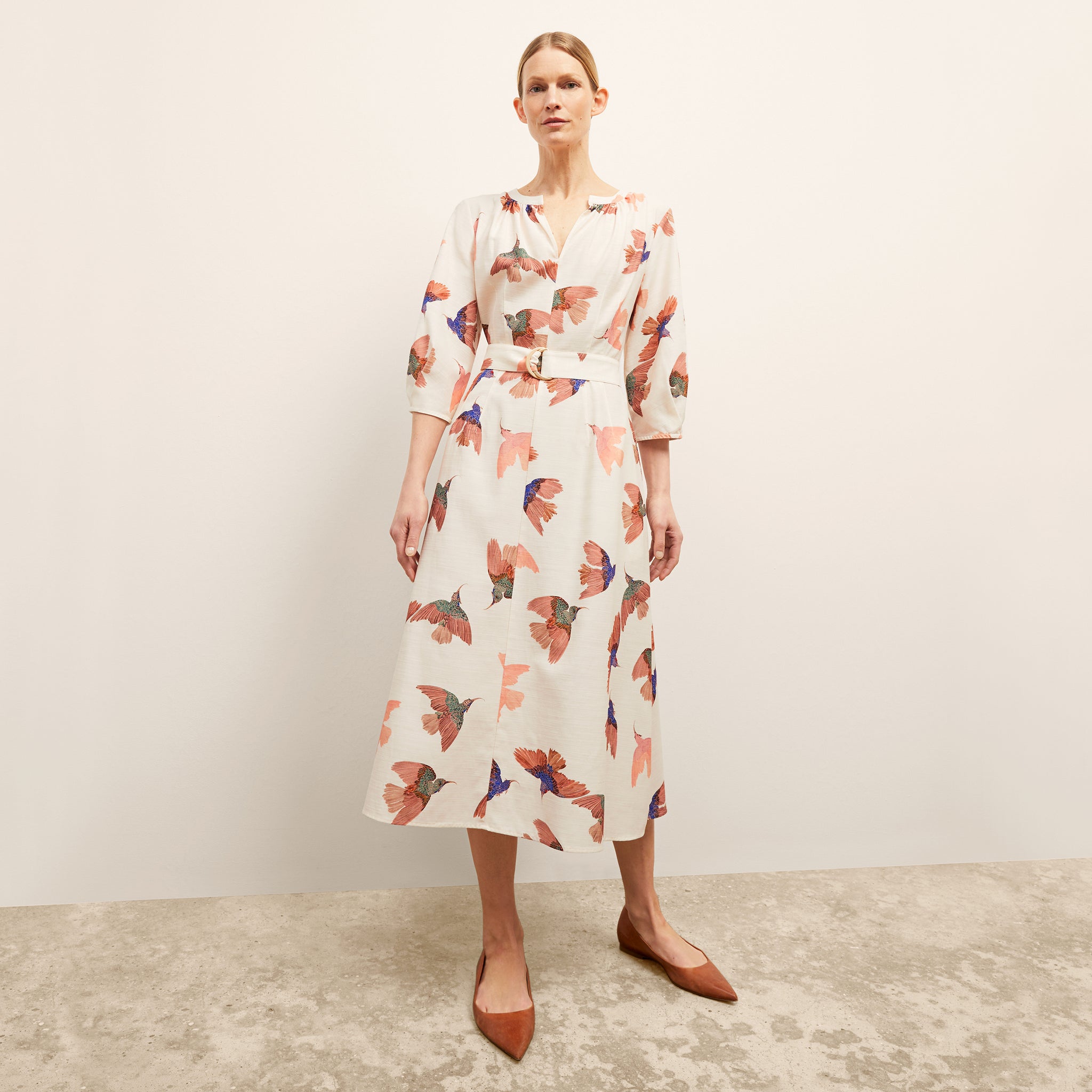 front image of a woman wearing the tessie dress in hummingbird print 