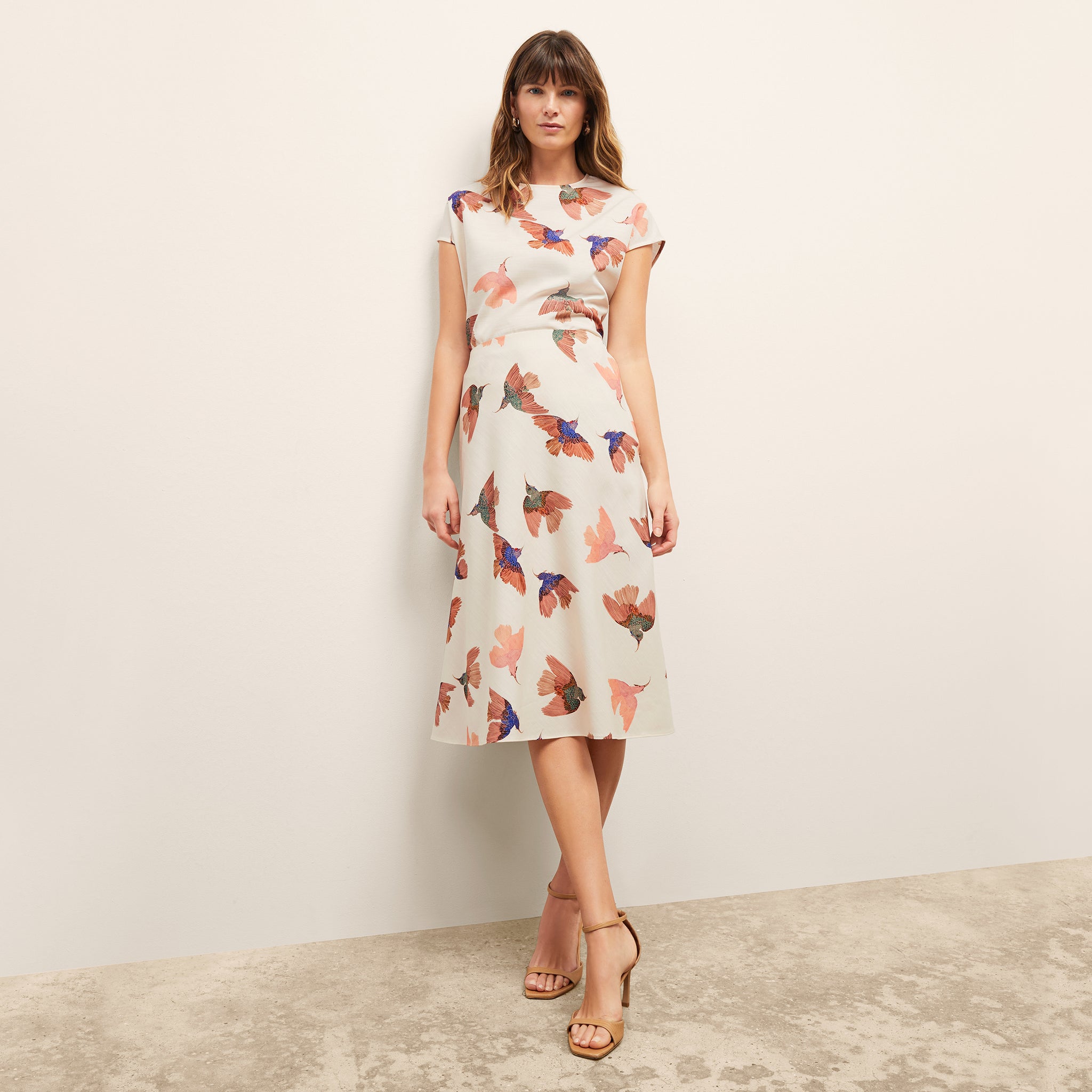 front image of a woman wearing the orchard skirt in hummingbird print