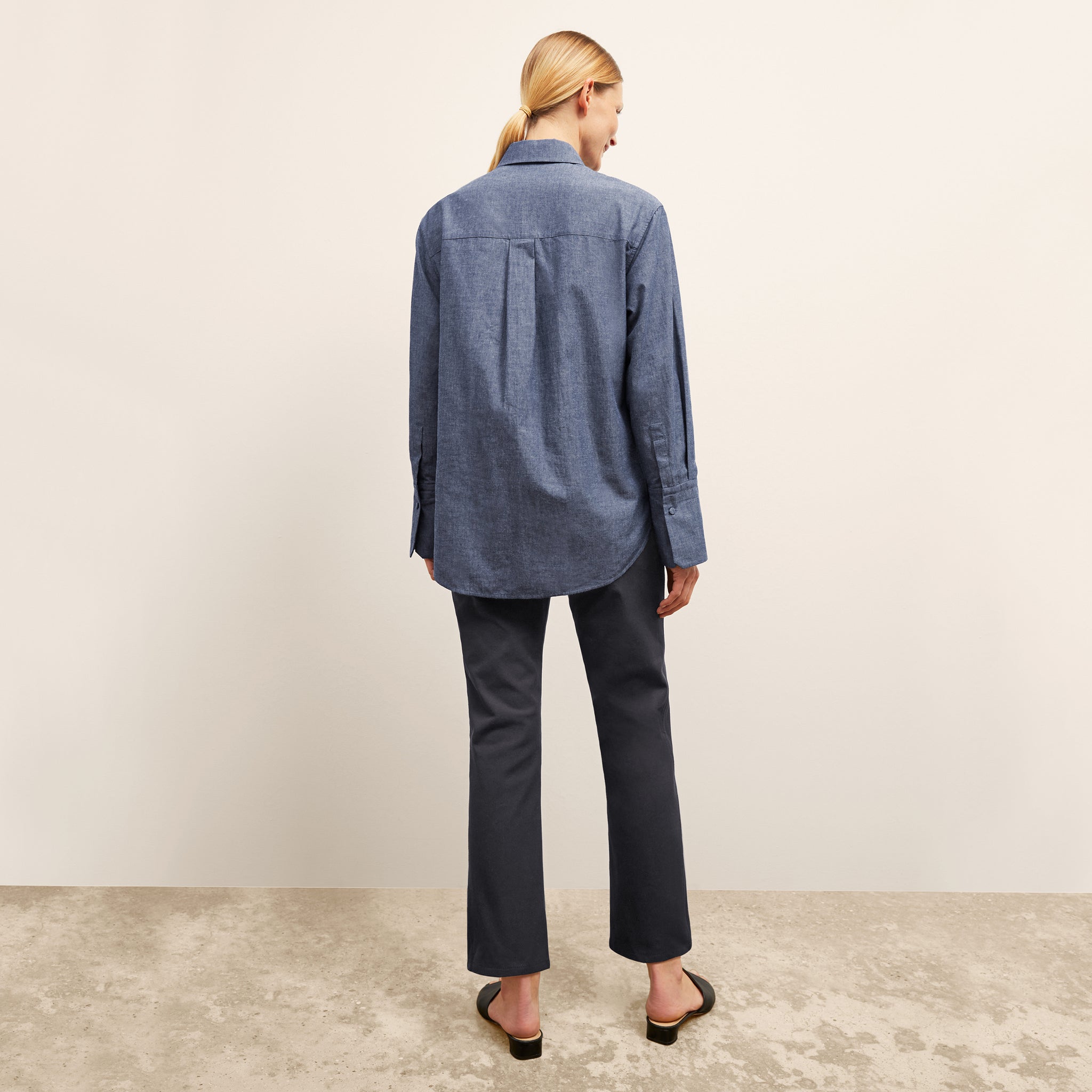 back image of a woman wearing the siobhan top in clear blue