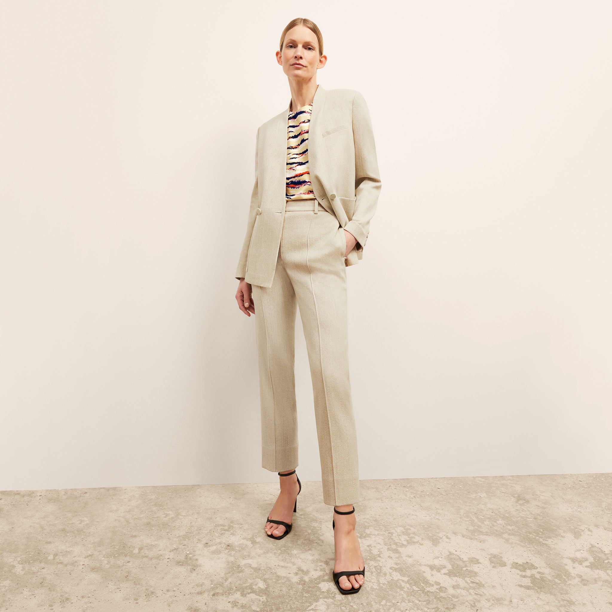 Front image of a woman wearing the Janette Jacket in ivory
