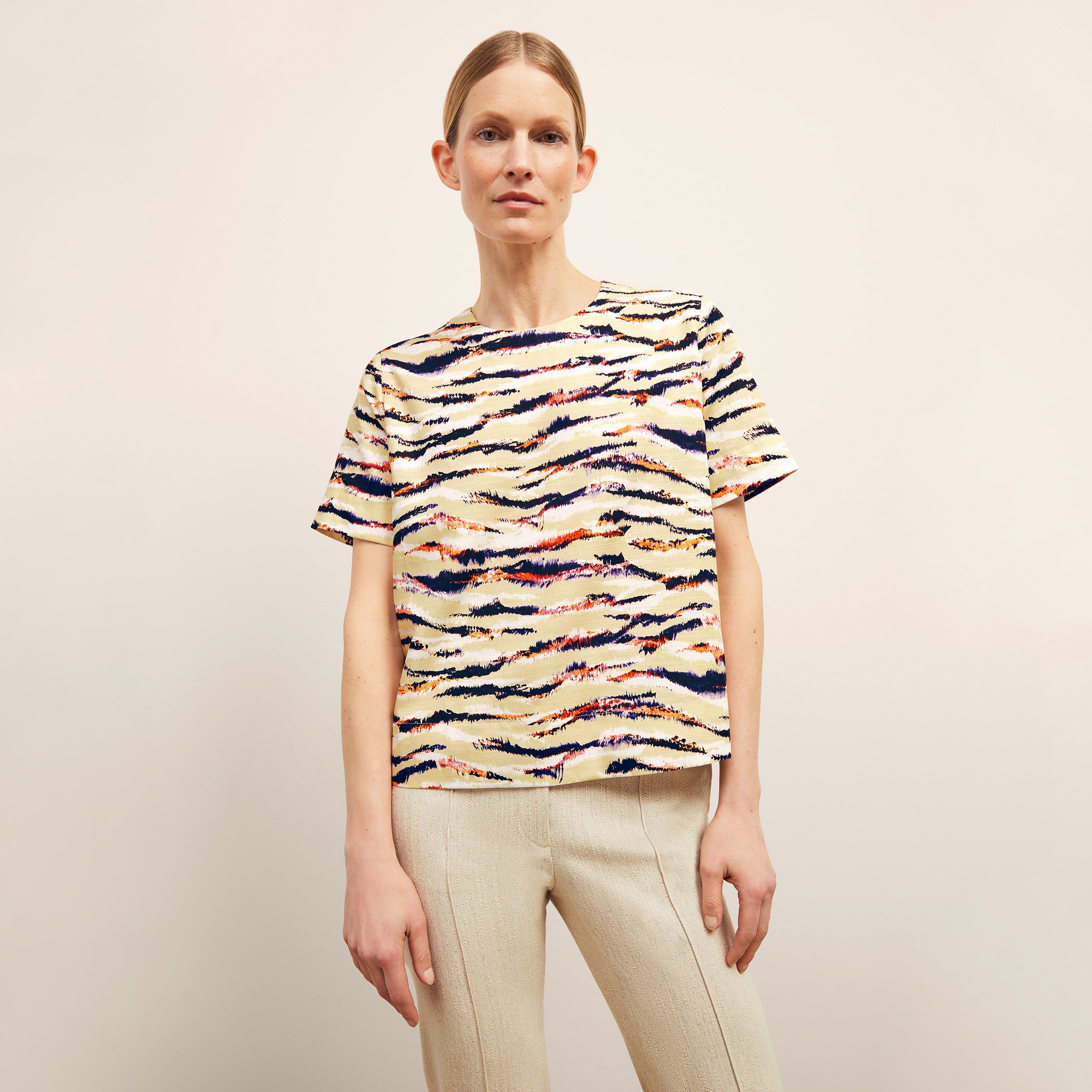 front image of a woman wearing the annika top in savannah print 