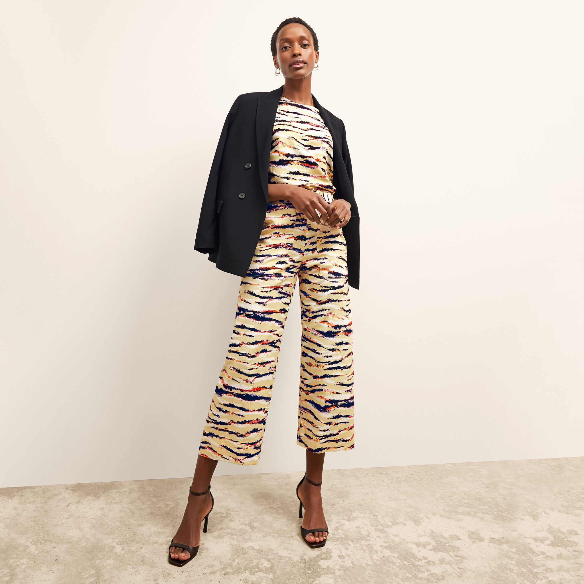 front image of a woman wearing the madelyn pant in savannah print