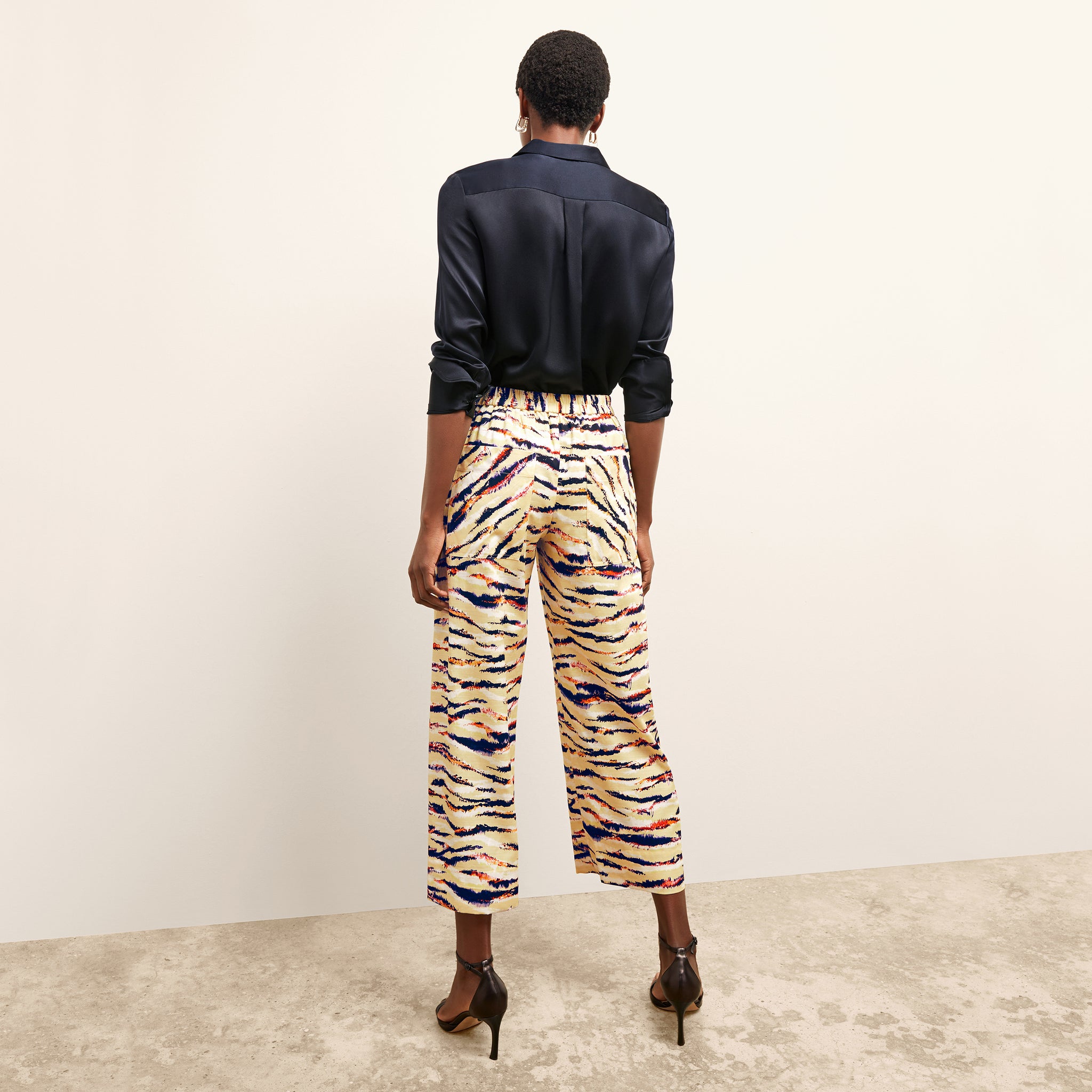 back image of a woman wearing the madelyn pant in savannah print