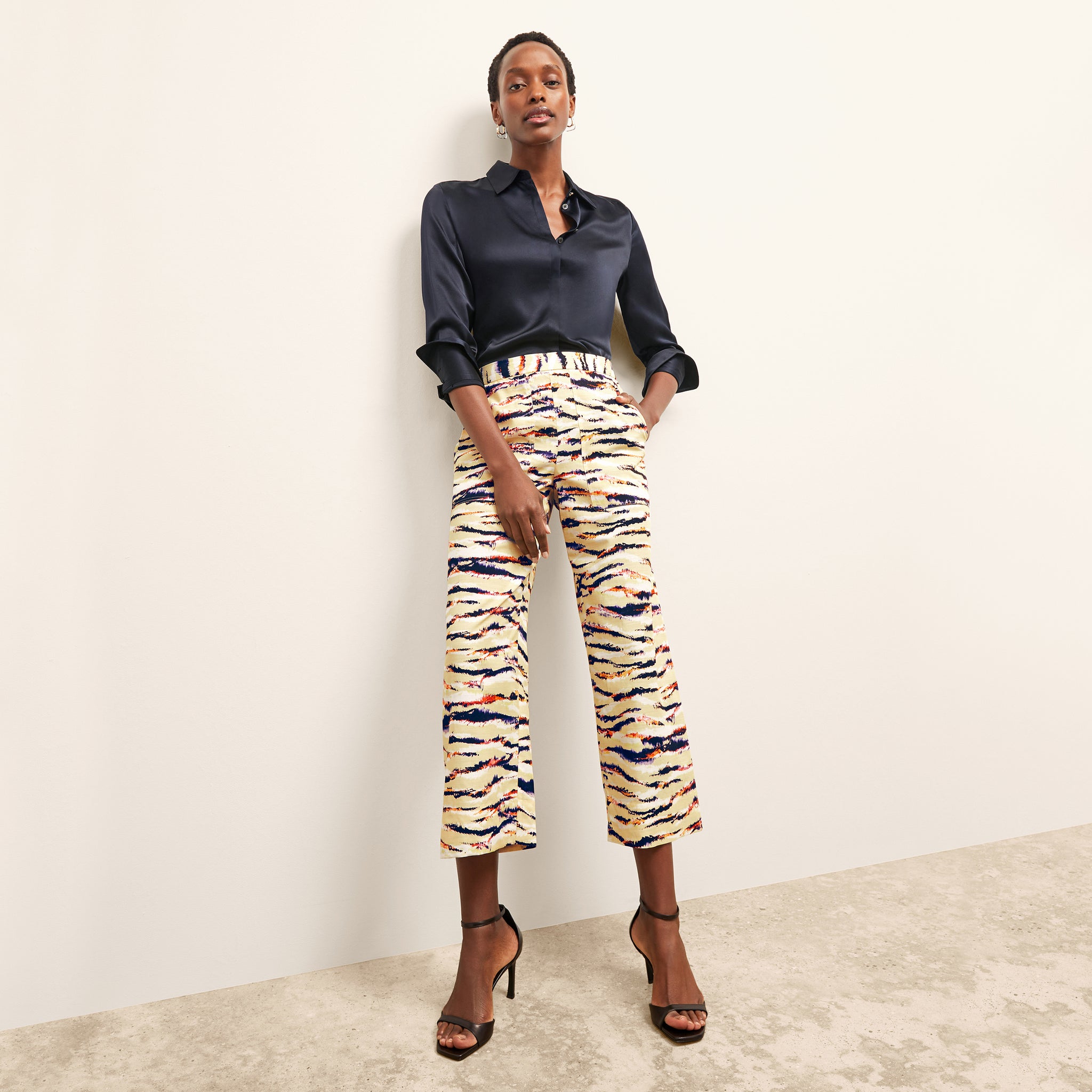 front image of a woman wearing the madelyn pant in savannah print 