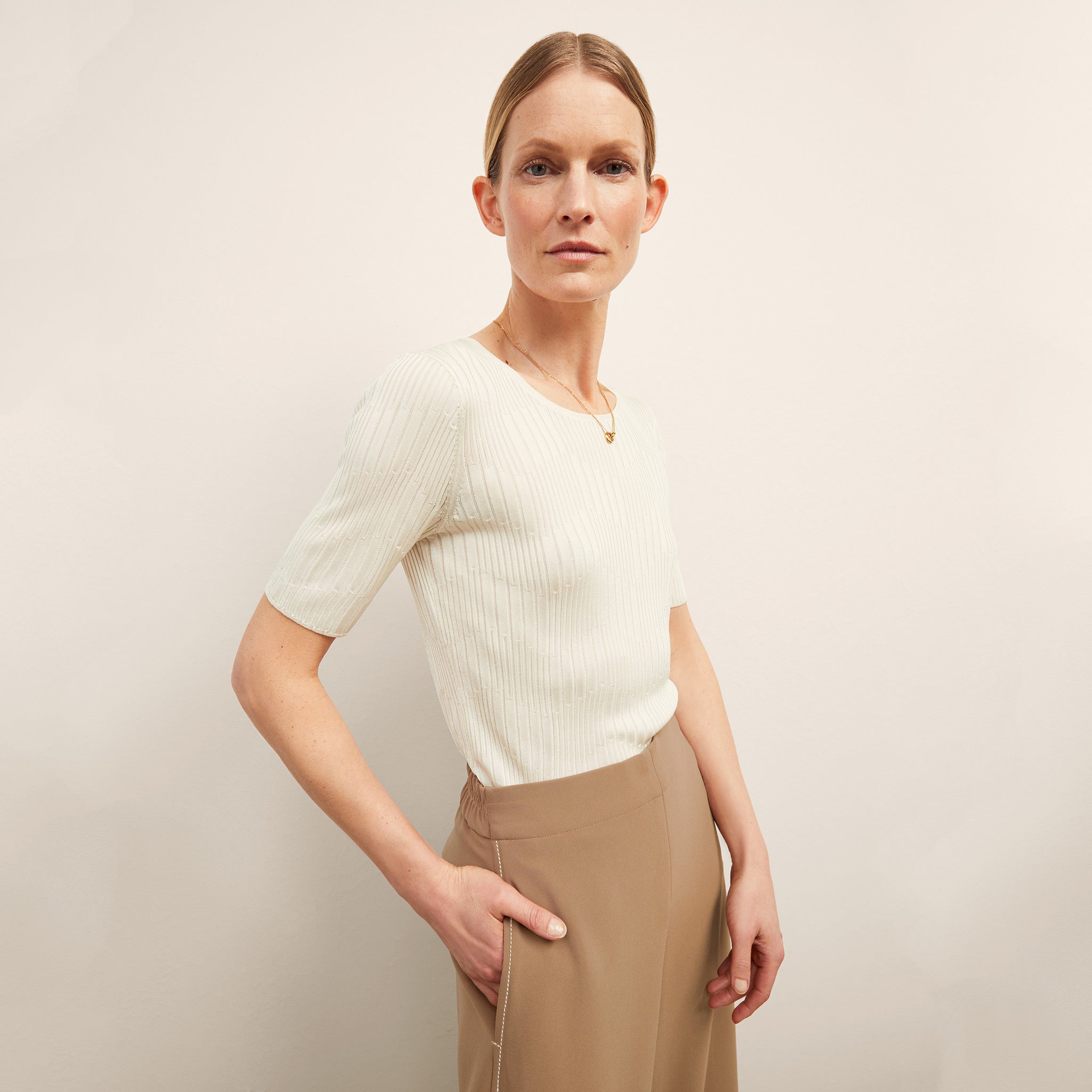 front image of a woman wearing the charlie top in ivory
