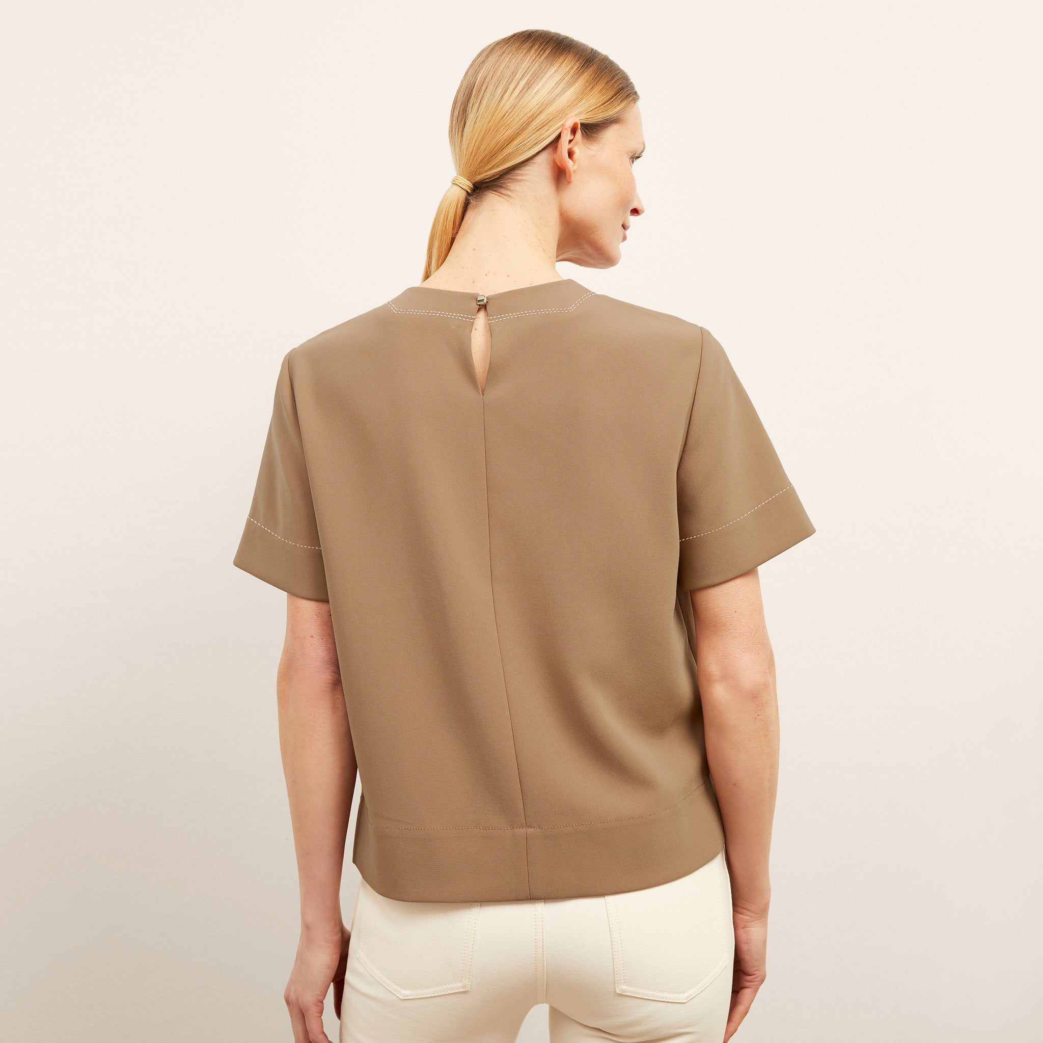 back image of a woman wearing the annika top in saddle