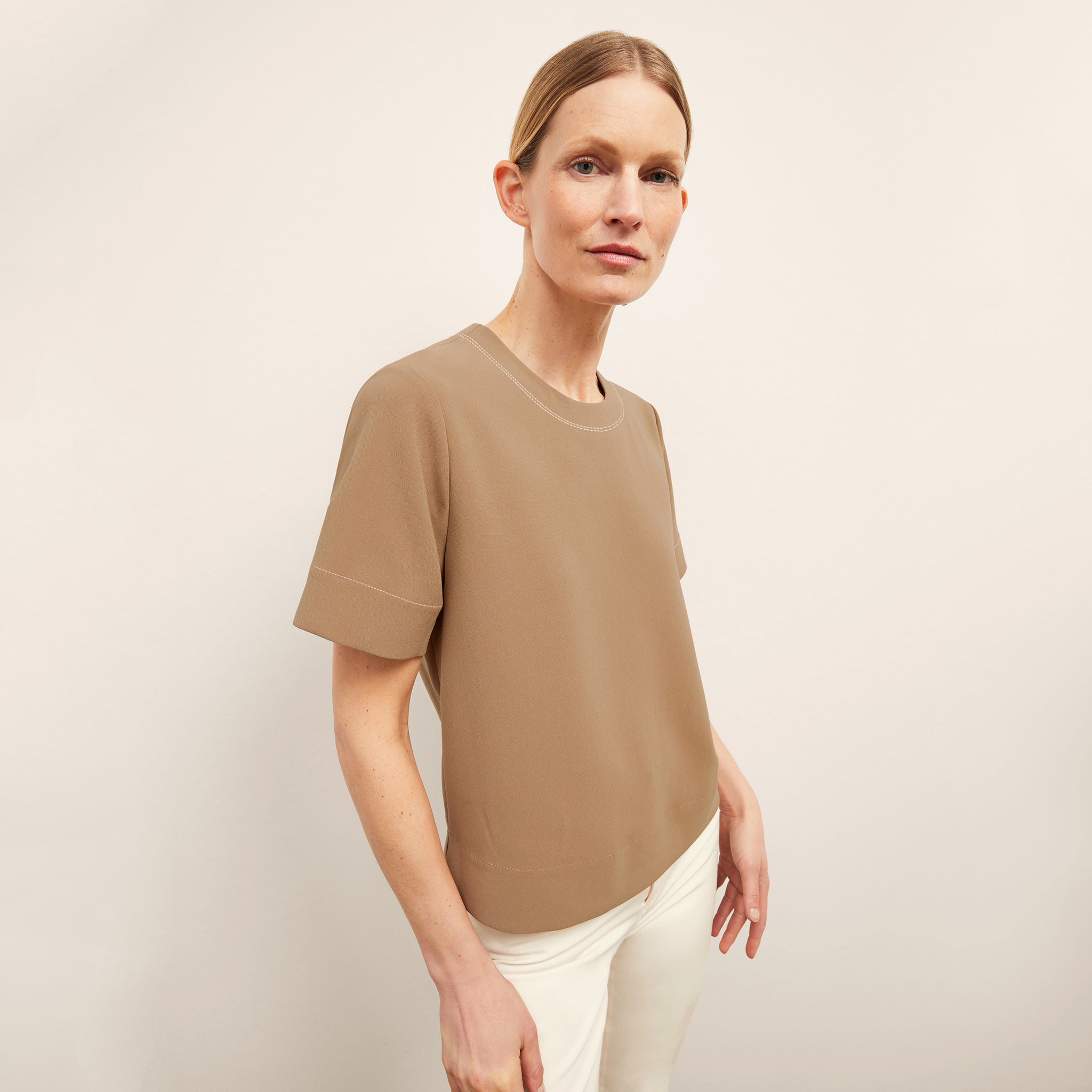 front image of a woman wearing the annika top in saddle