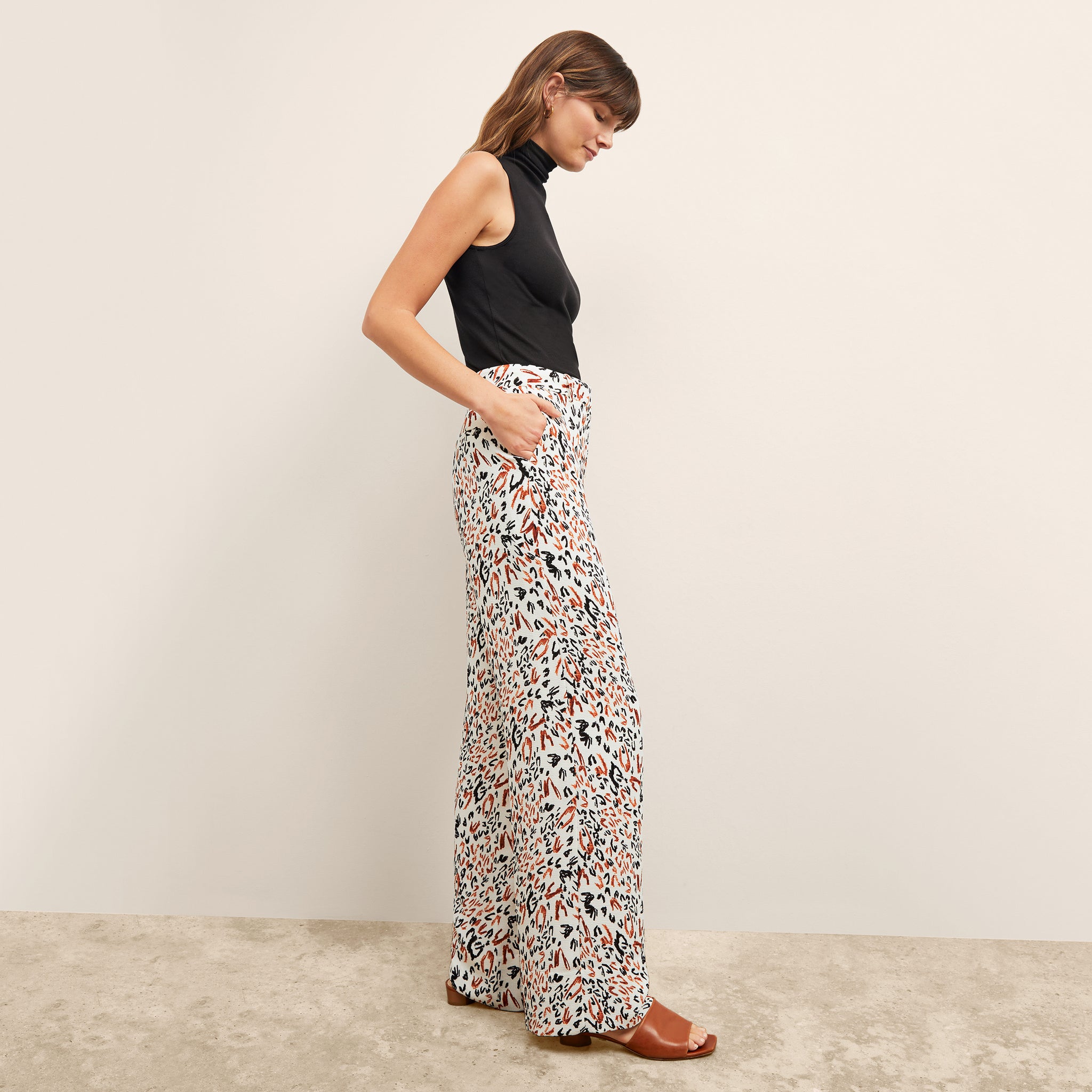 side image of a woman wearing the tinsley trousers in leopard sketch