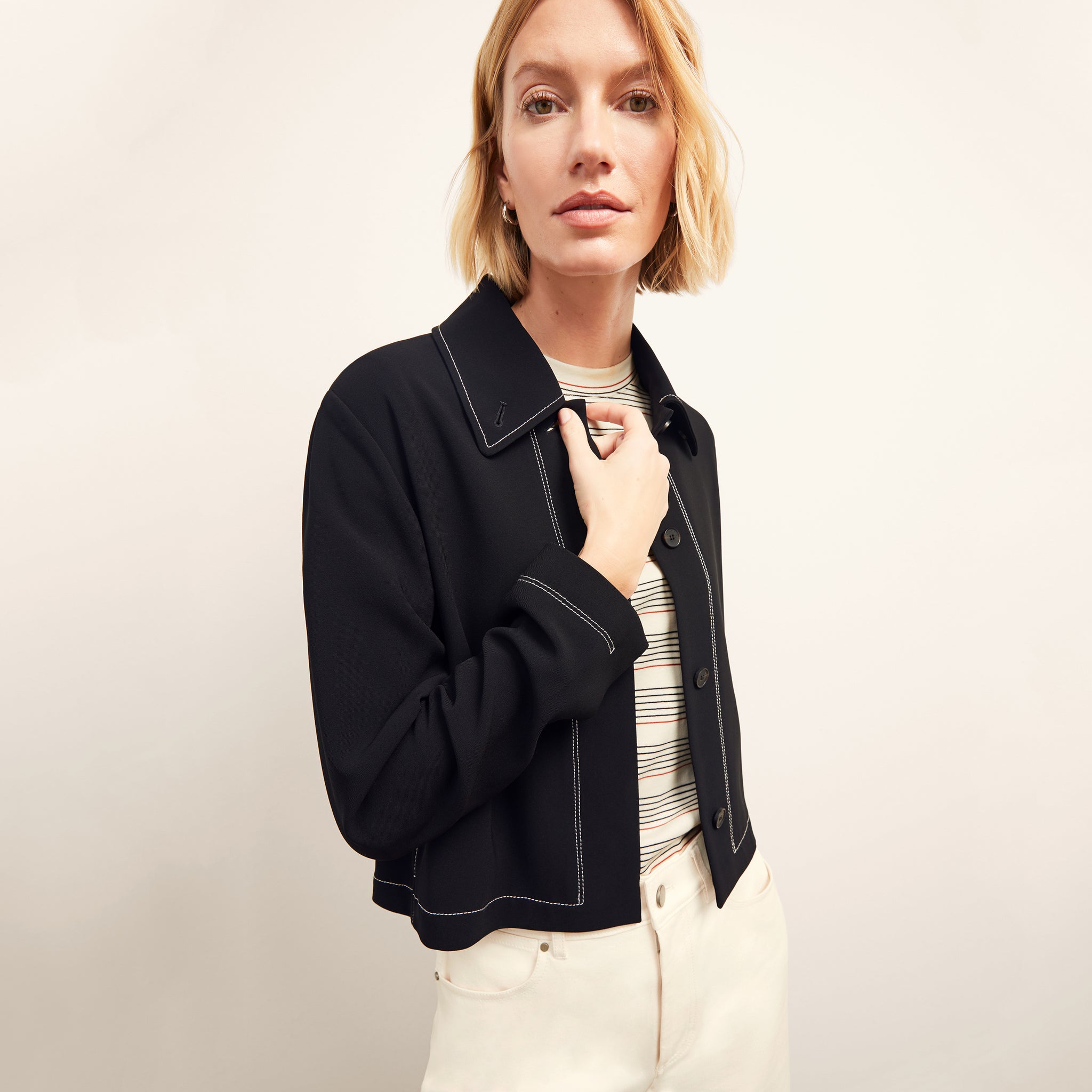 front image of a woman wearing the nicky jacket in black 