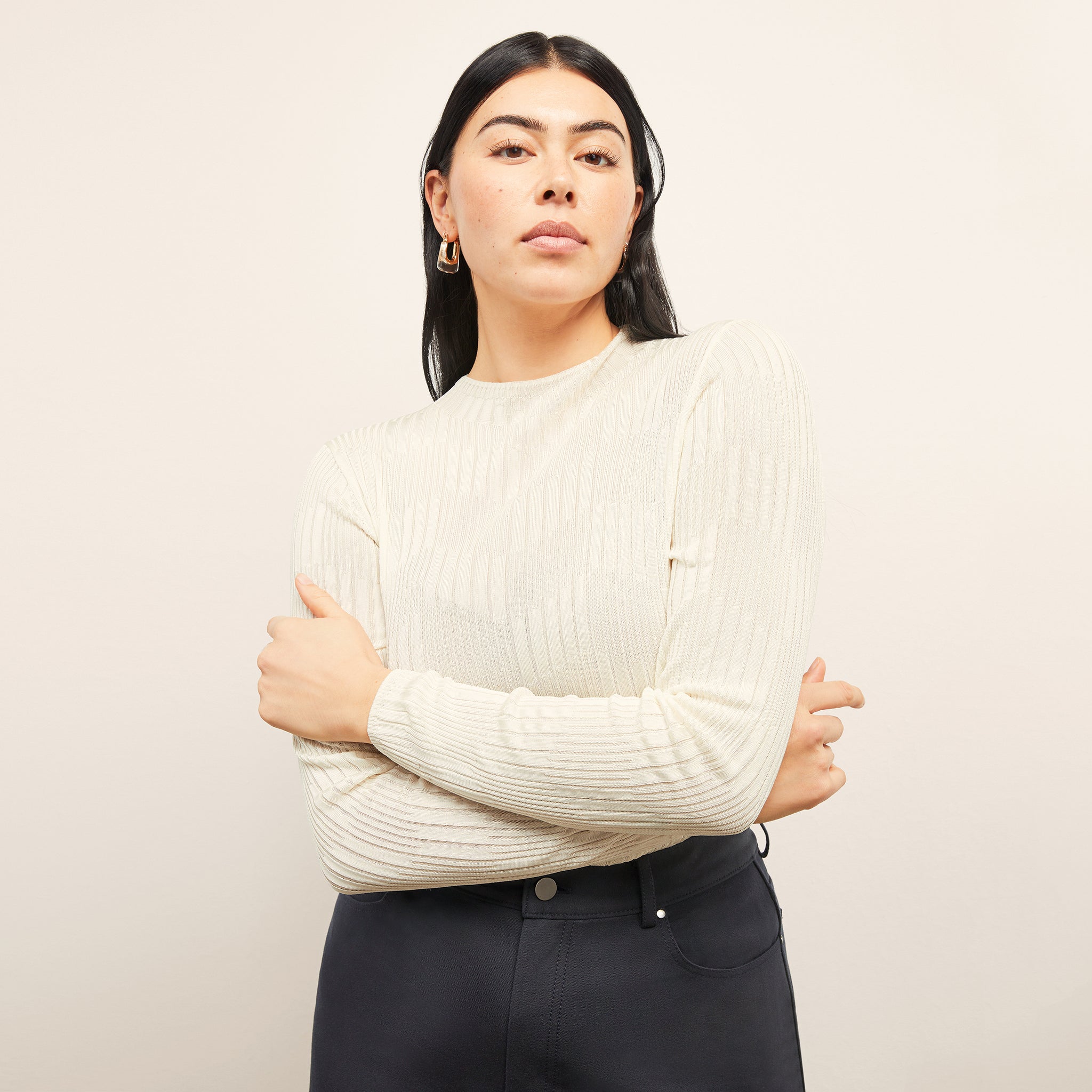 front image of a woman wearing the brodie top in ivory 
