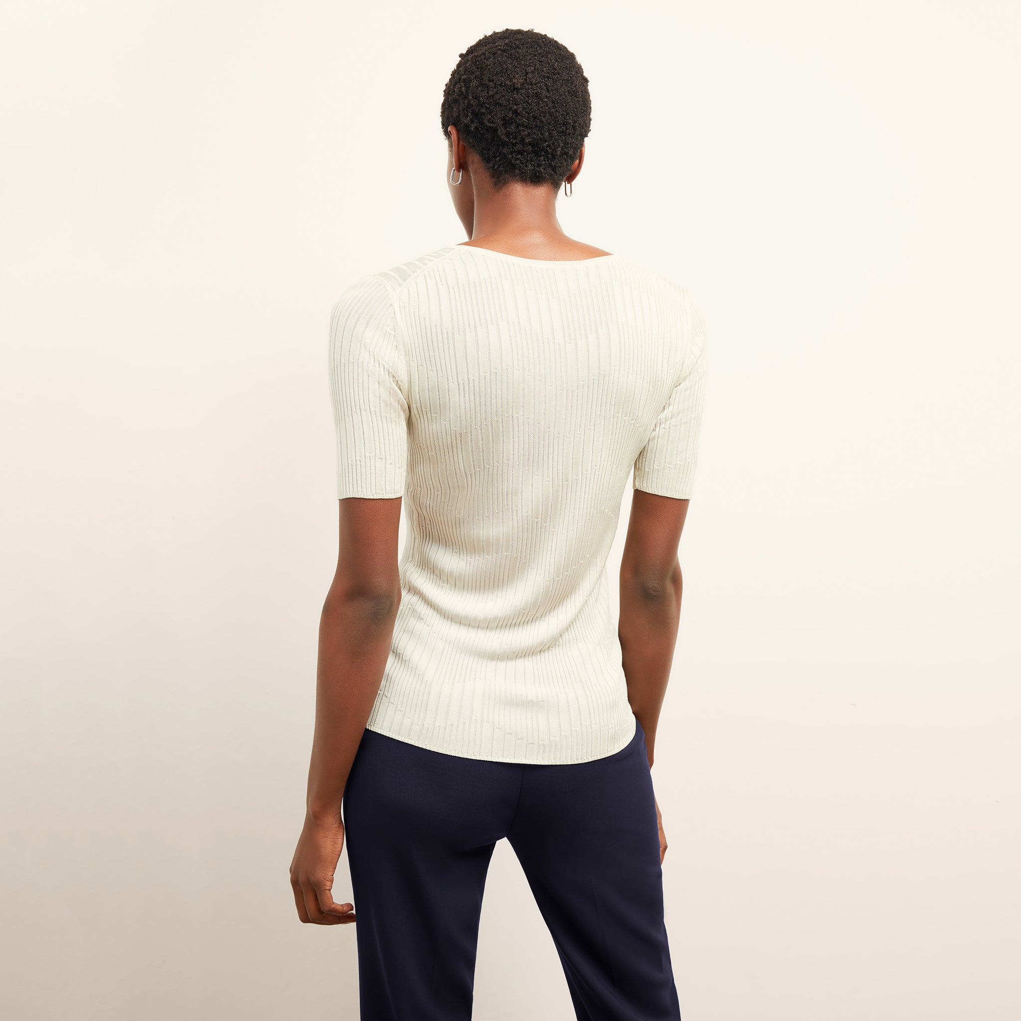 back image of a woman wearing the charlie top in ivory