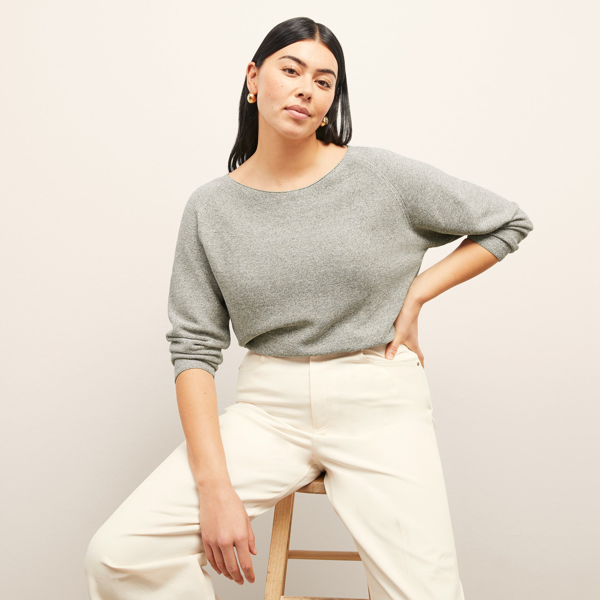 front image of a woman wearing the chadwick sweater in olive melange