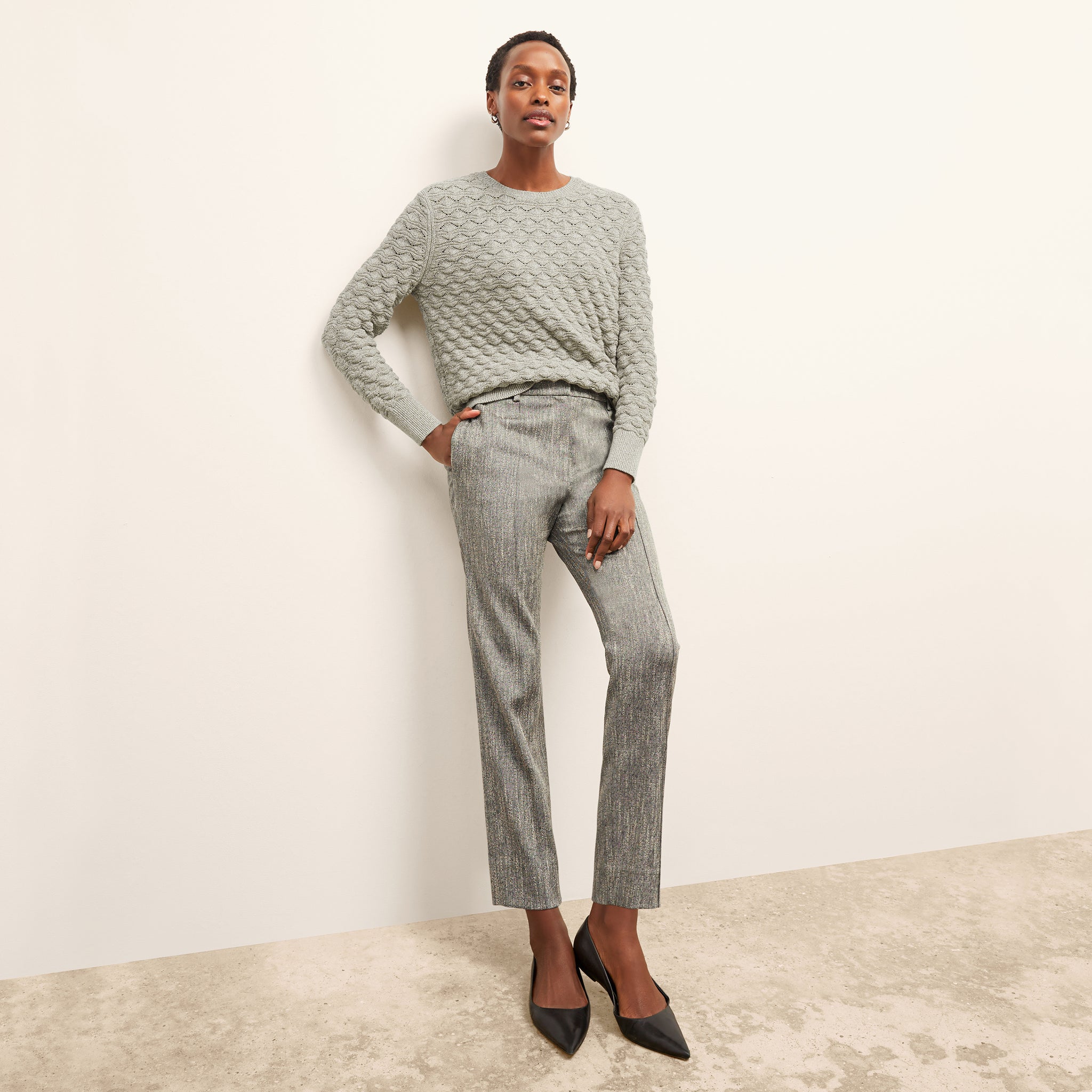 front image of a woman wearing the butler sweater in olive melange 