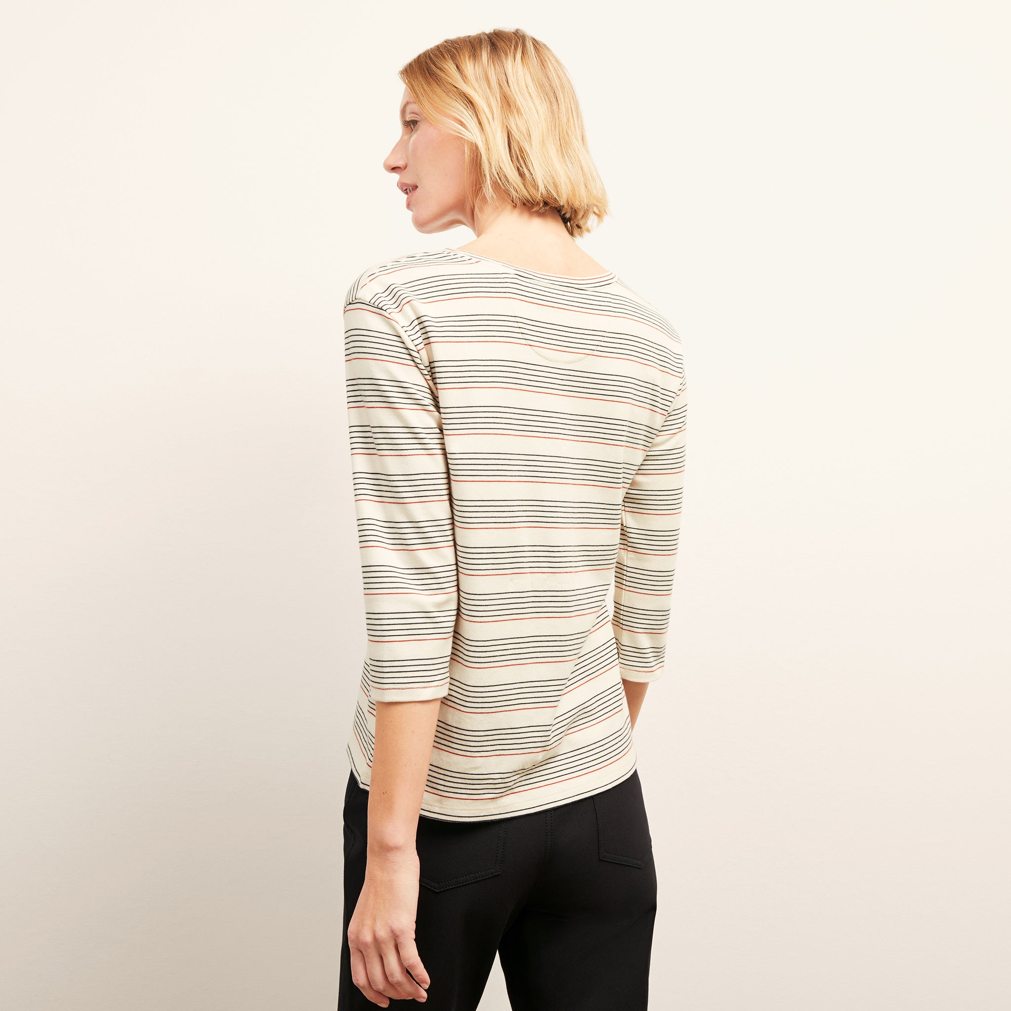 back image of a woman wearing the owen t-shirt in signature stripe