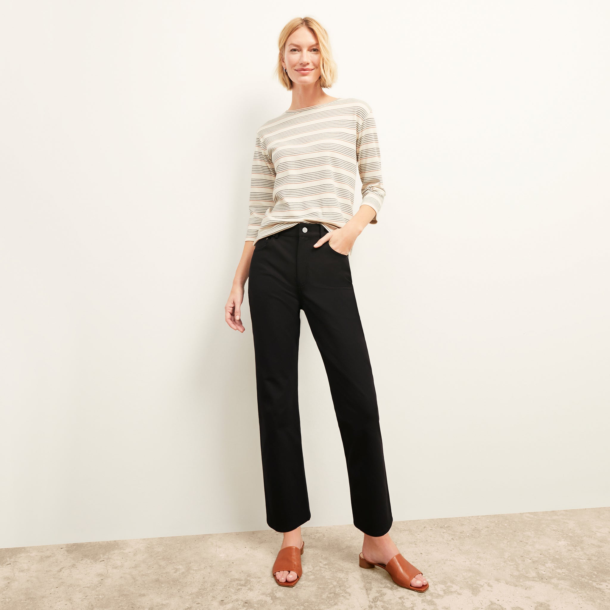 Front image of a woman in the daria pant in black