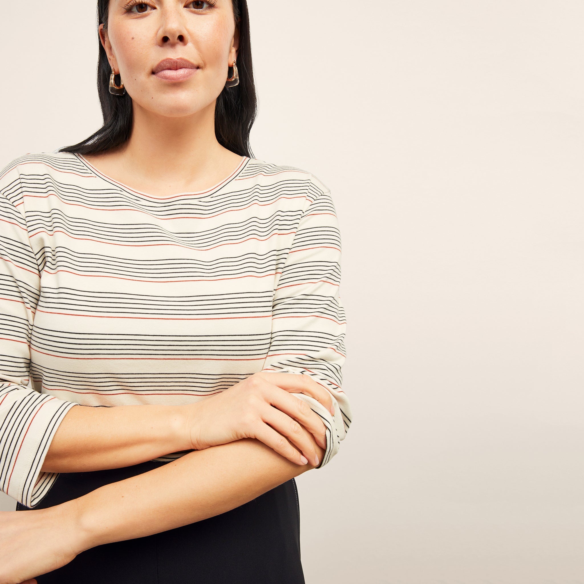 front image of a woman wearing the owen t-shirt in signature stripe