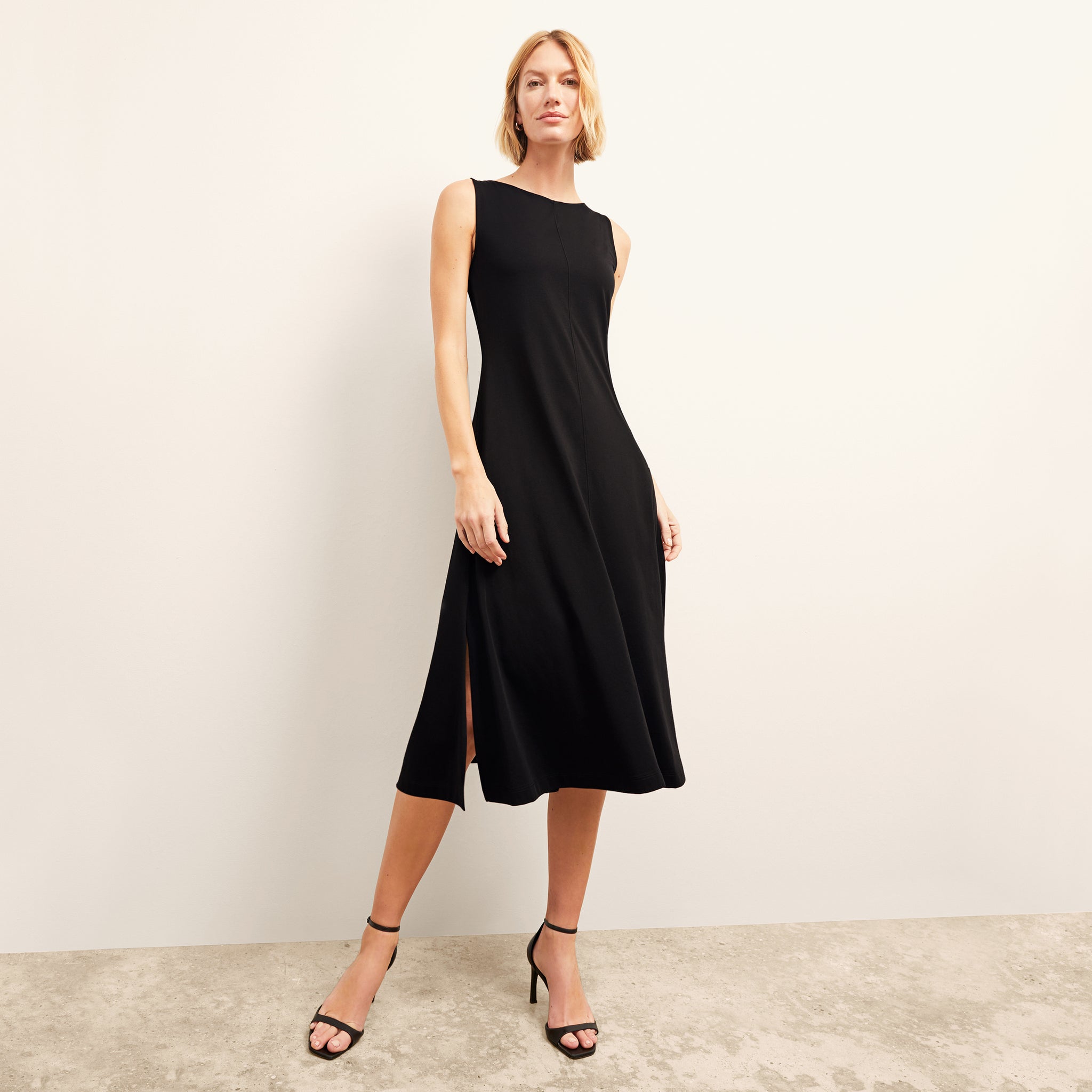 front image of a woman wearing the milano dress in black 