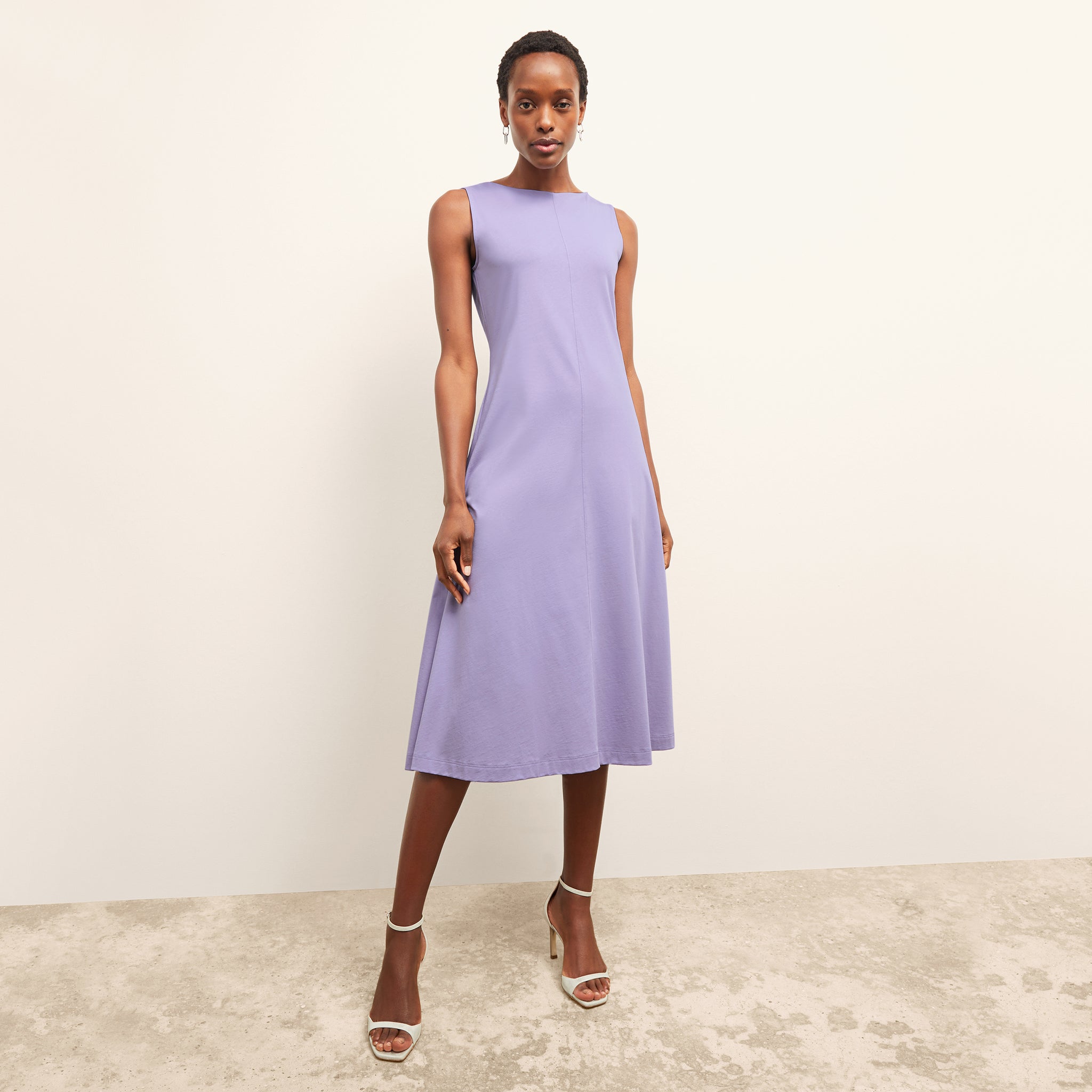 front image of a woman wearing the milano dress in light orchid 