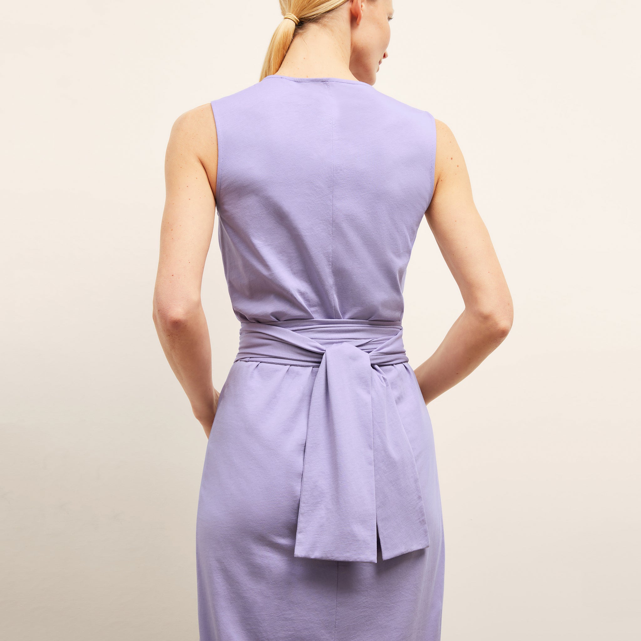 back image of a woman wearing the monte dress in light orchid