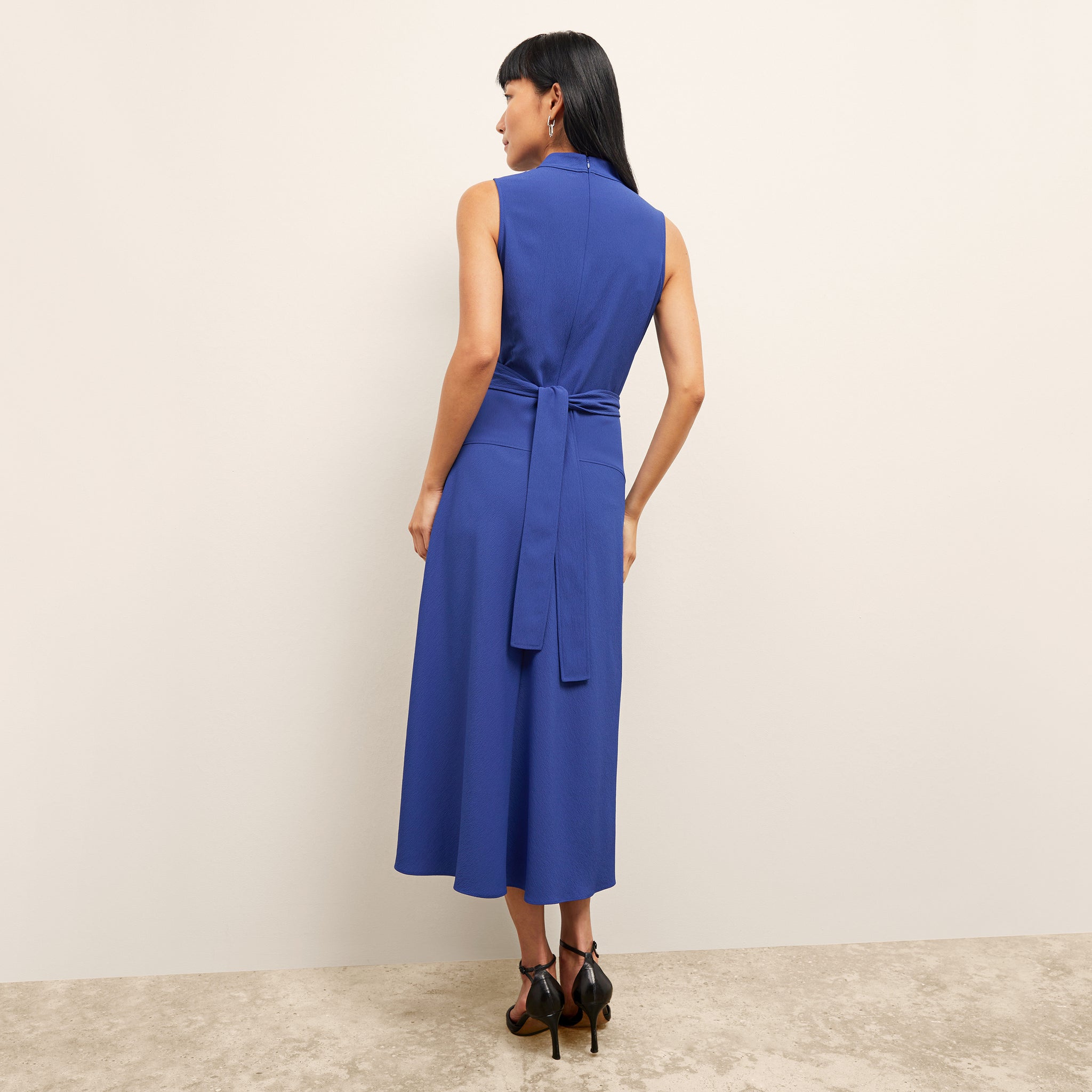back image of a woman wearing the martina dress in royal blue