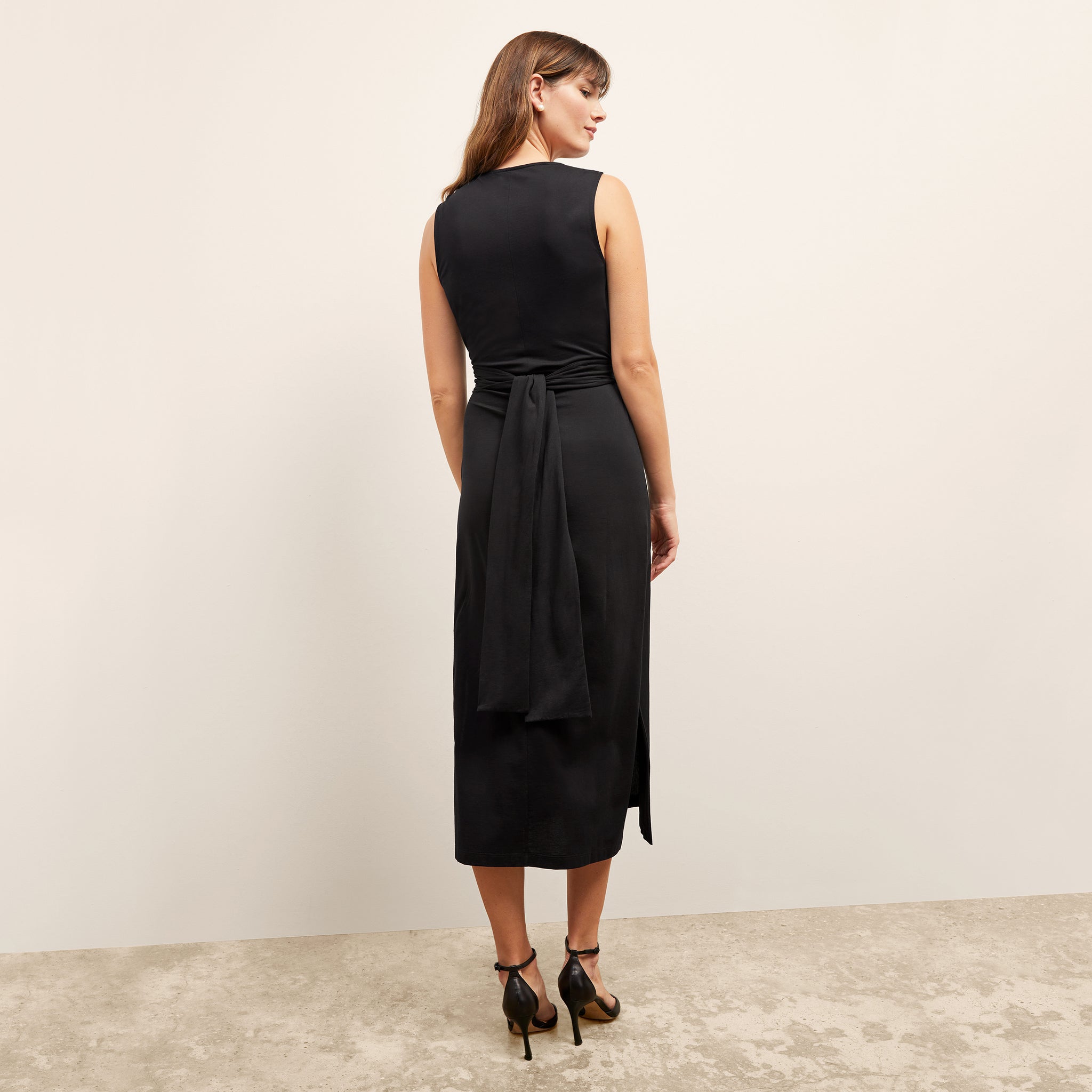 back image of a woman wearing the monte dress in black
