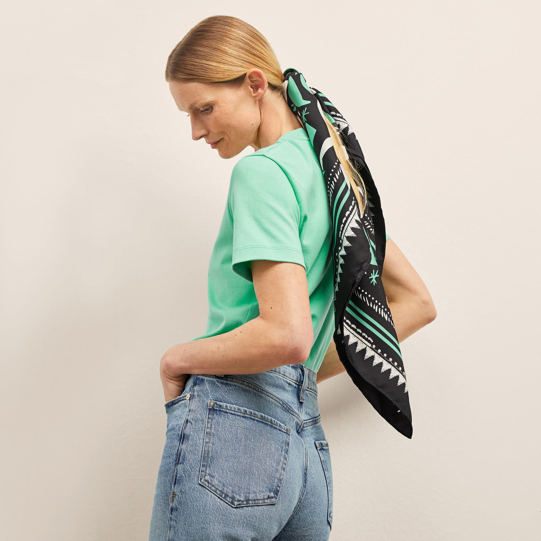 image of a woman wearing the washable silk scarf in seafoam icon print 
