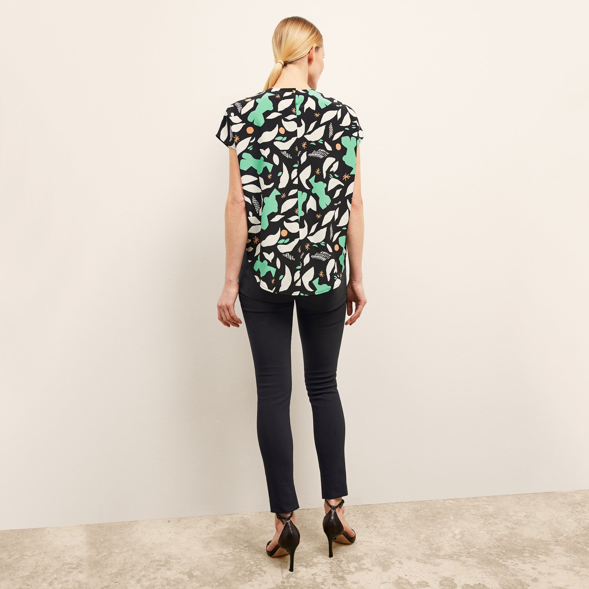 image of a woman wearing the didion top in seafoam icon print