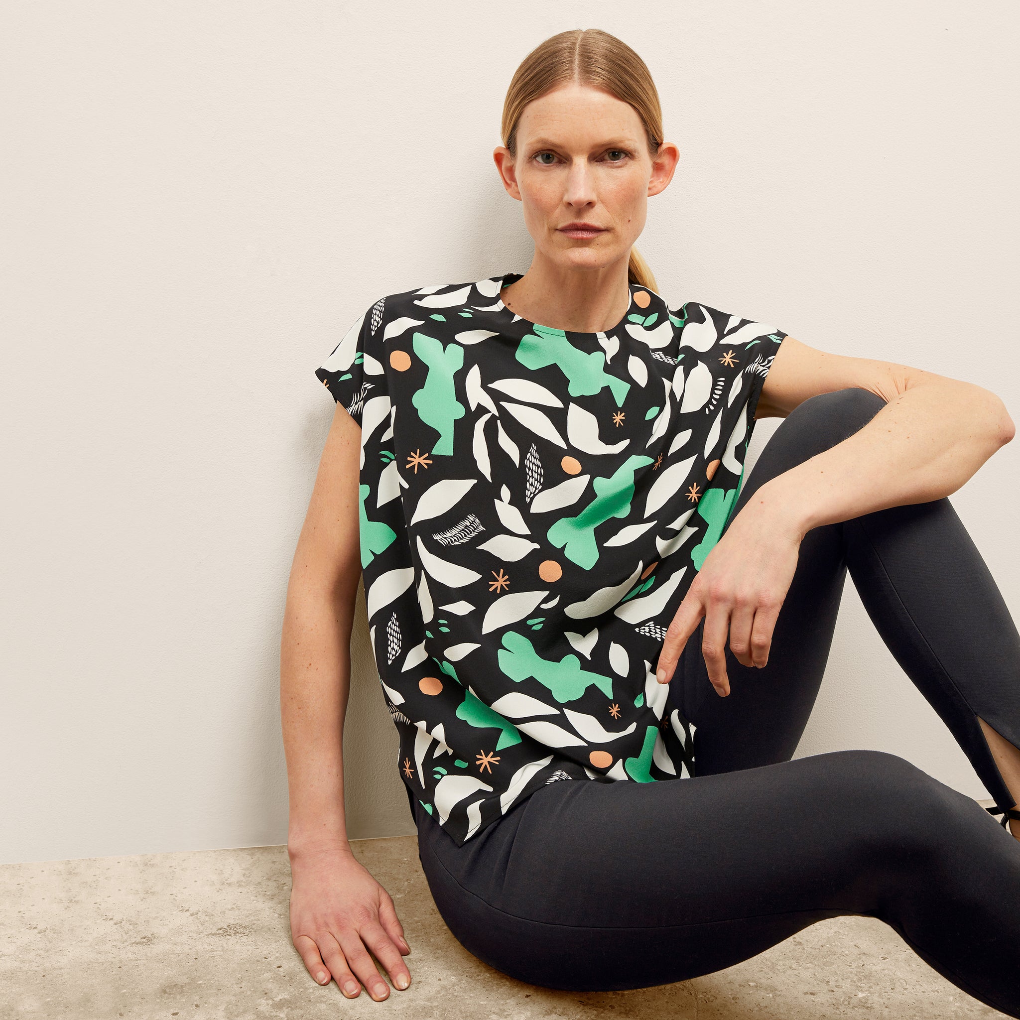 image of a woman wearing the didion top in seafoam icon print 
