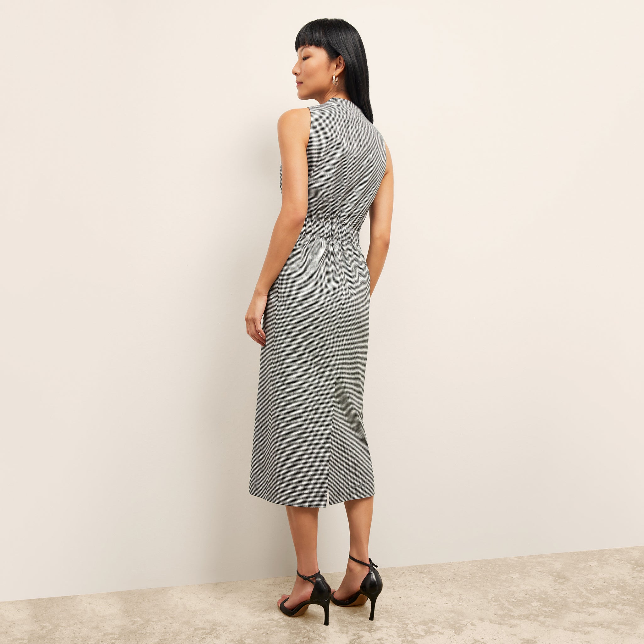 back image of a woman wearing the cassandra dress in gingham linen