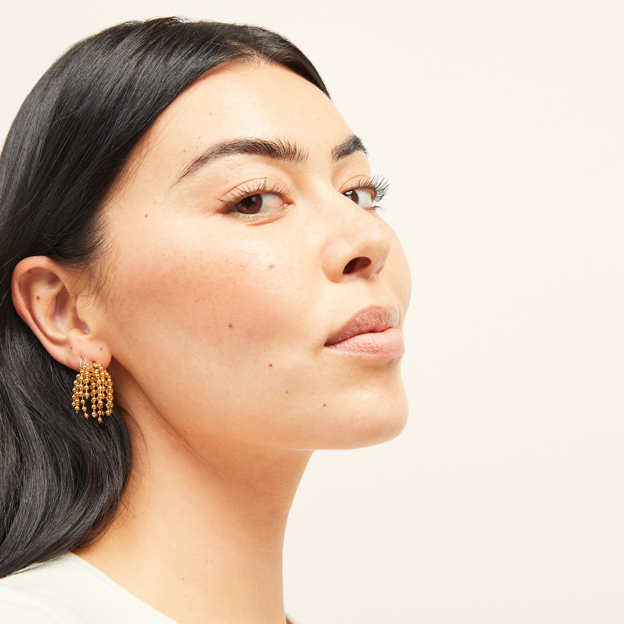 image of a woman wearing the elsie earring in gold