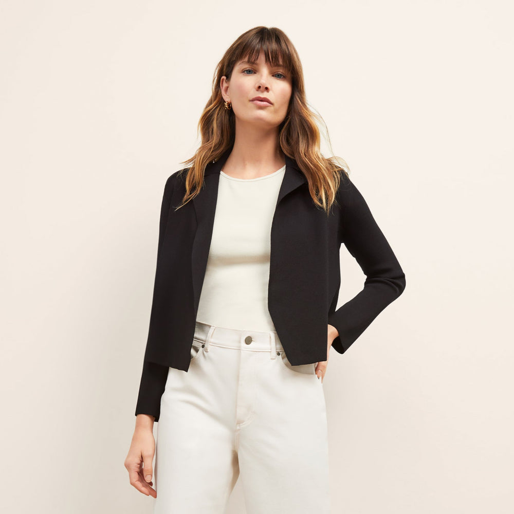 Front image of a woman sitting wearing the Jolie Jardigan in Black