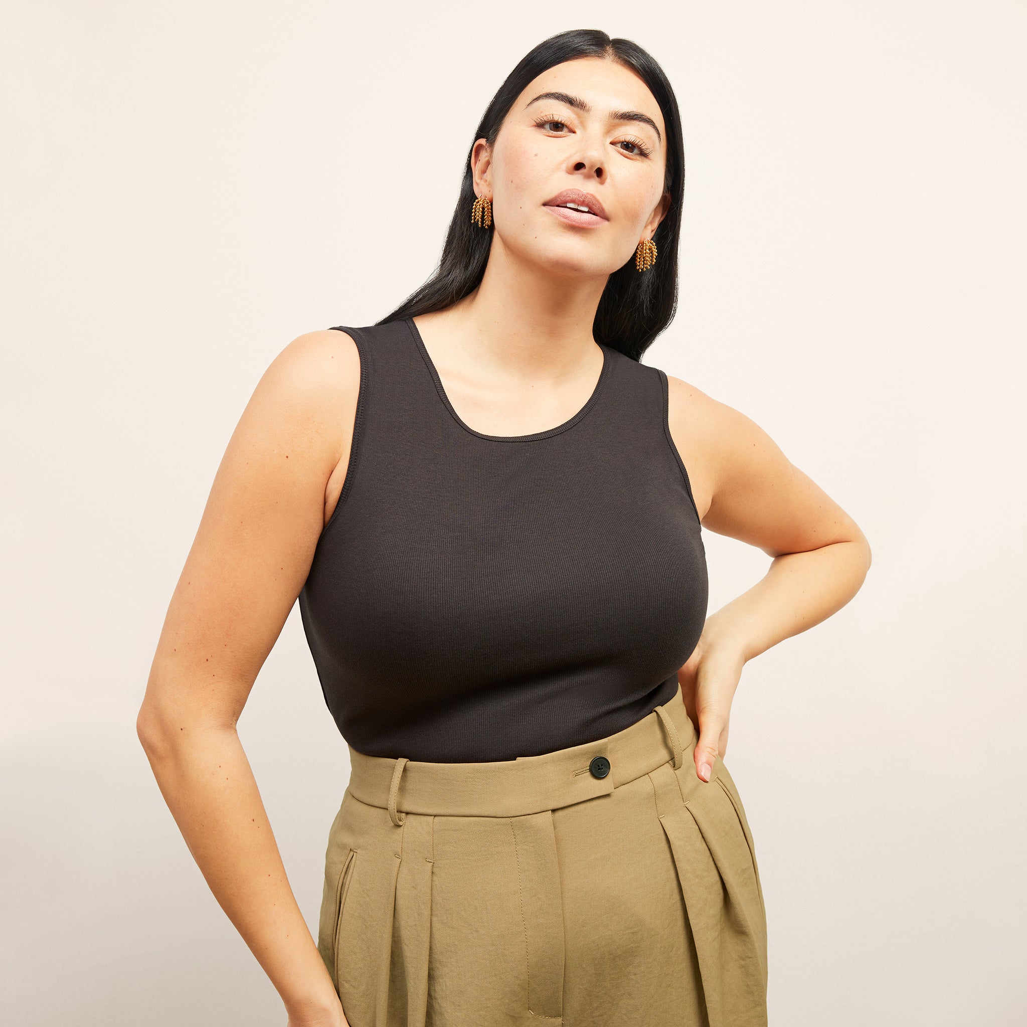 Front image of a woman standing wearing the paige top in fine ribbed cotton in black 
