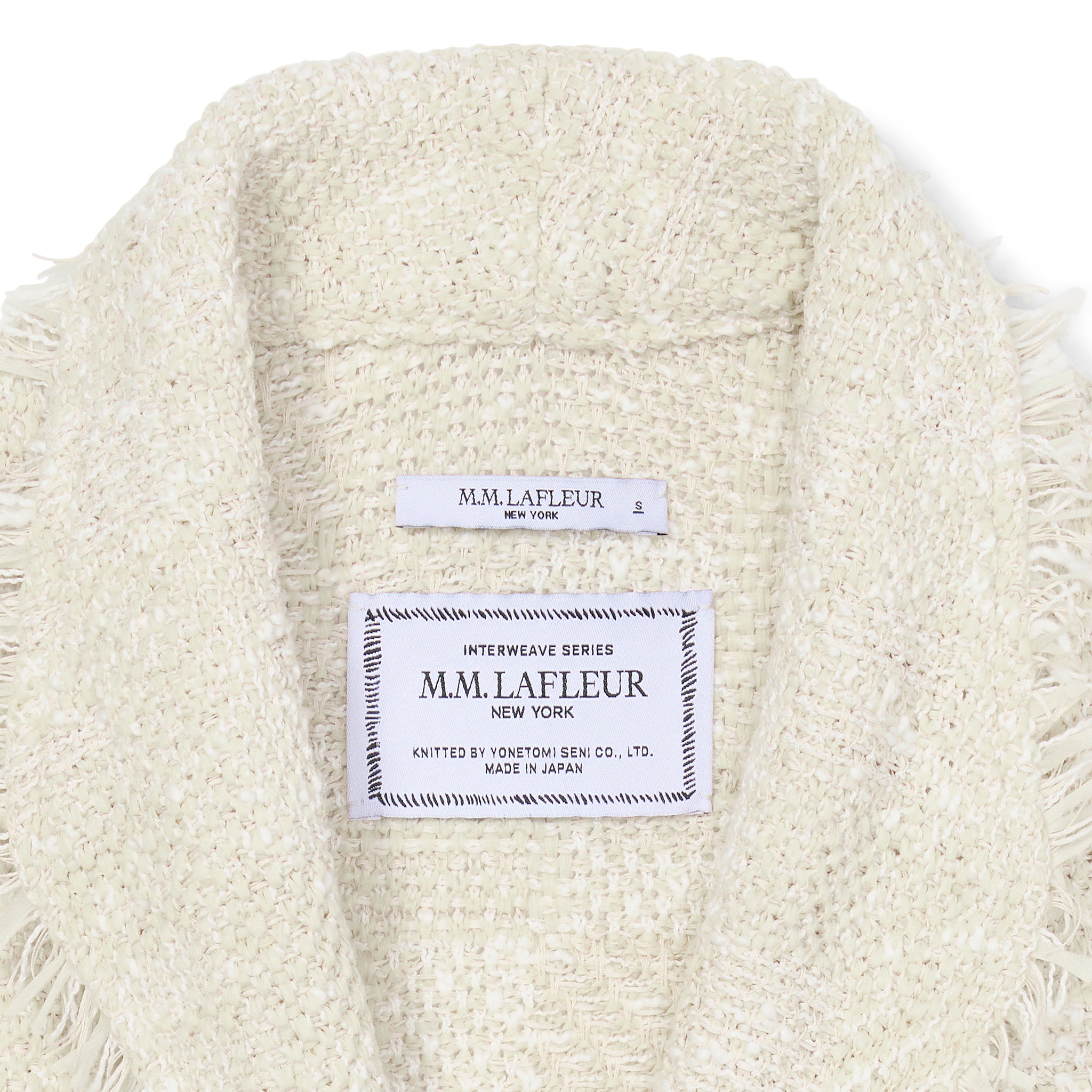 close up image of the tag of the porter jacket in taupe and ivory