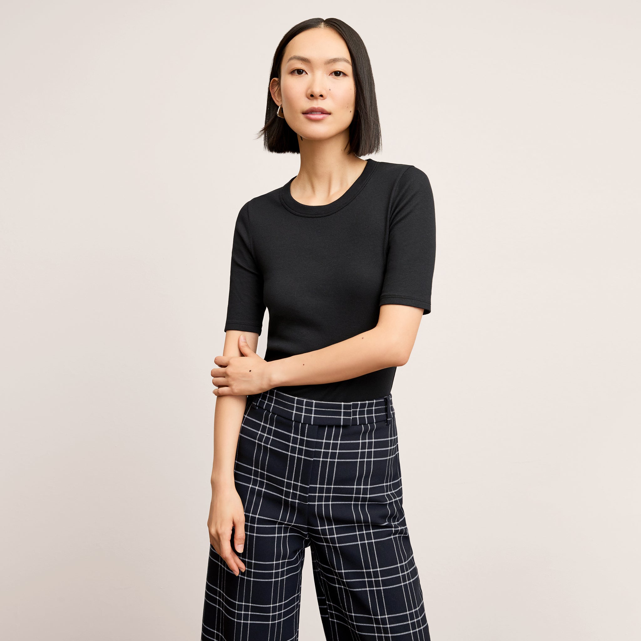 front image of a woman wearing the abby pant in plaid 