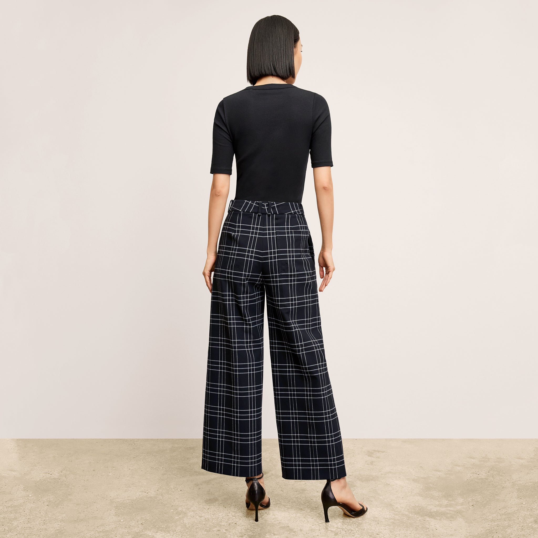 back image of a woman wearing the abby pant in plaid 