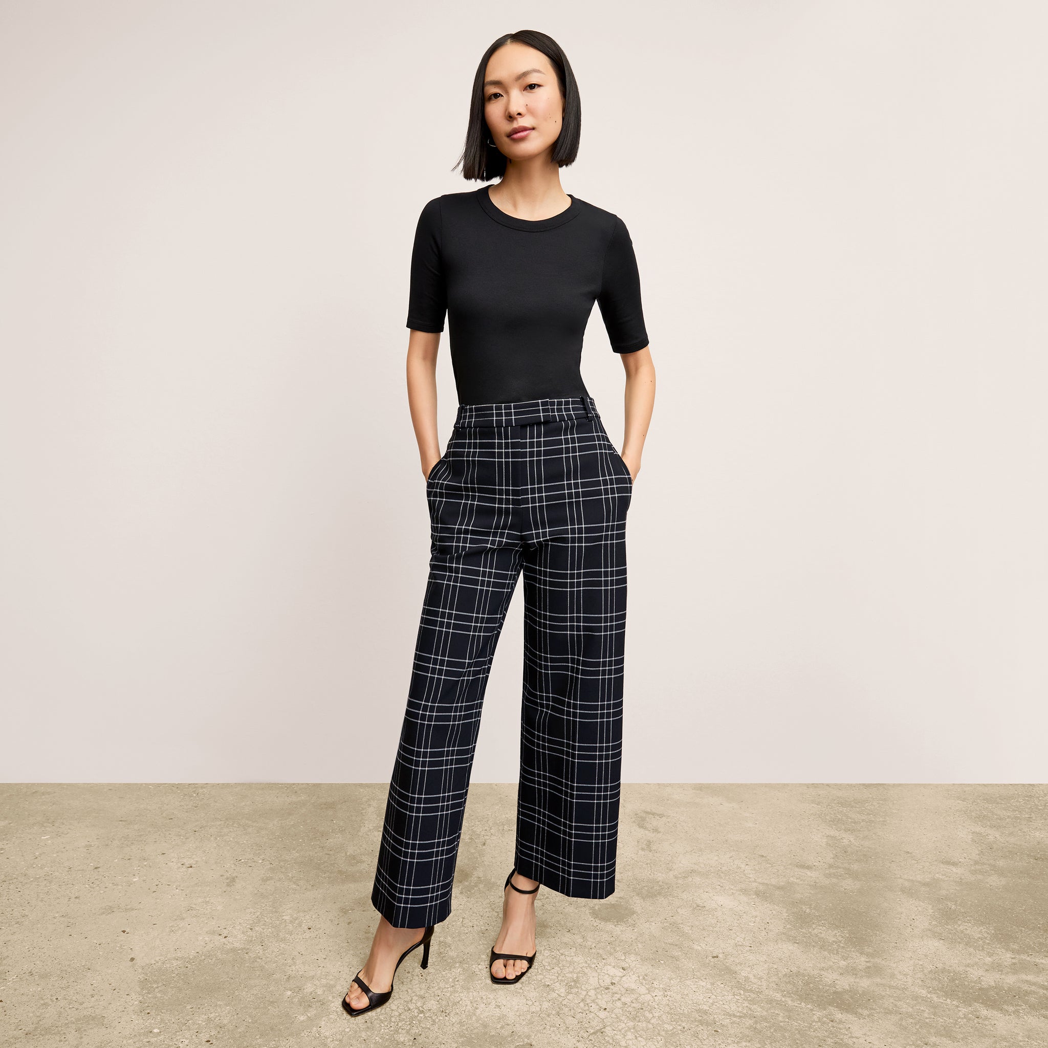 front image of a woman wearing the abby pant in plaid 