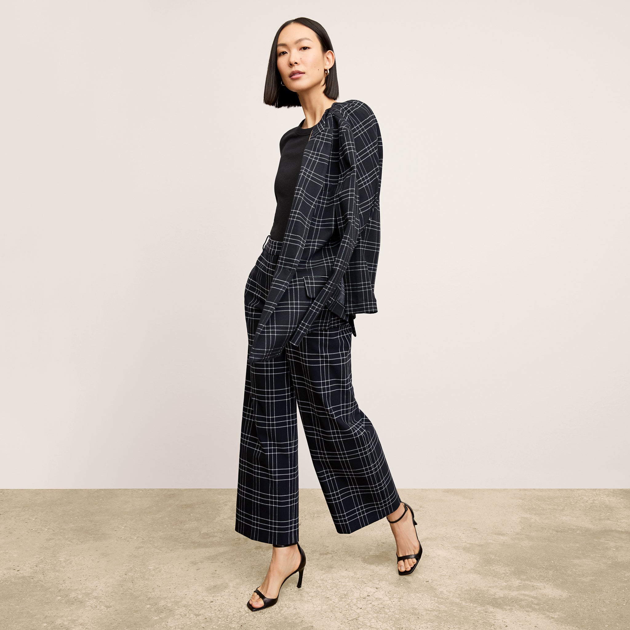 front image of a woman wearing the abby pant in plaid 