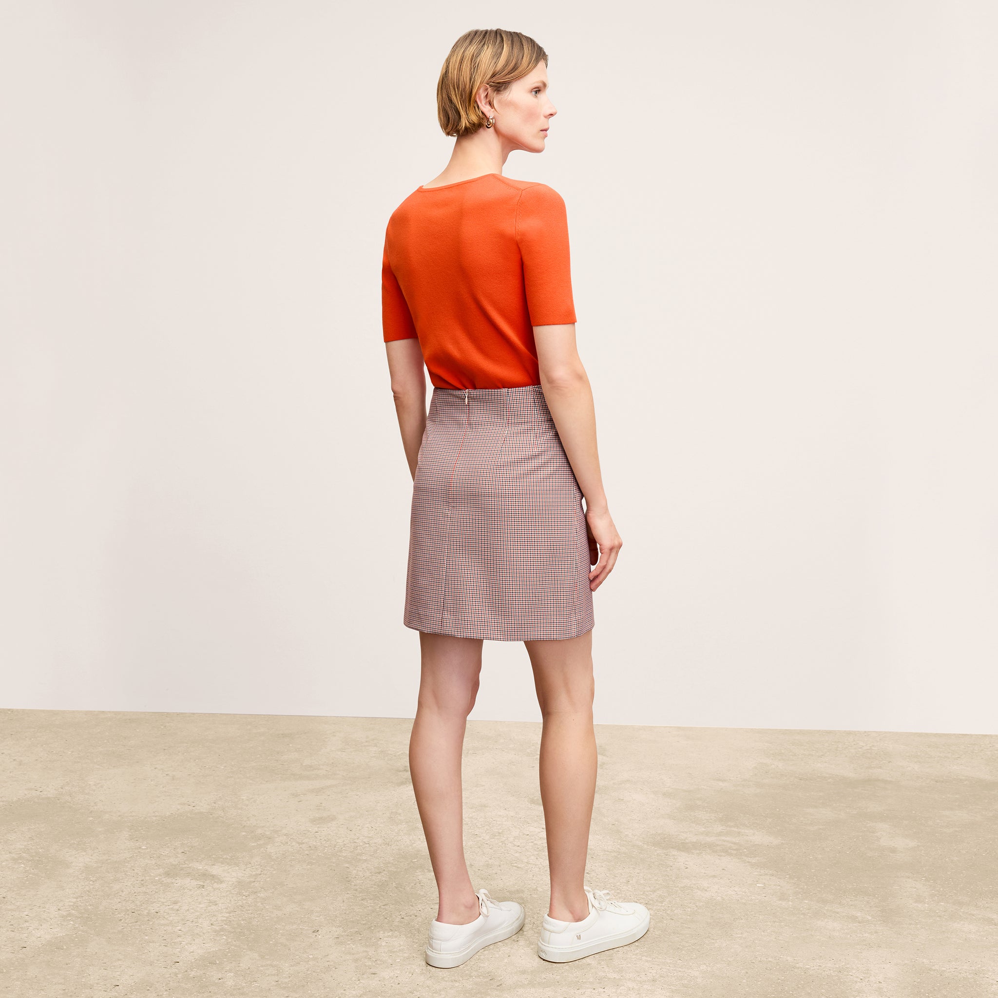 Back image of a woman wearing the Choe Top in Apricot