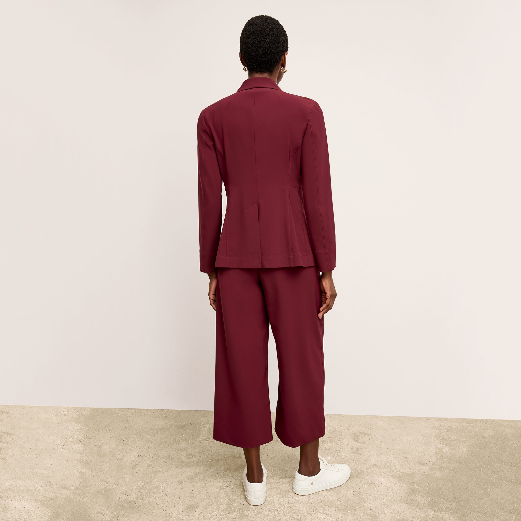 back image of a woman wearing the moreland jacket in berry jam