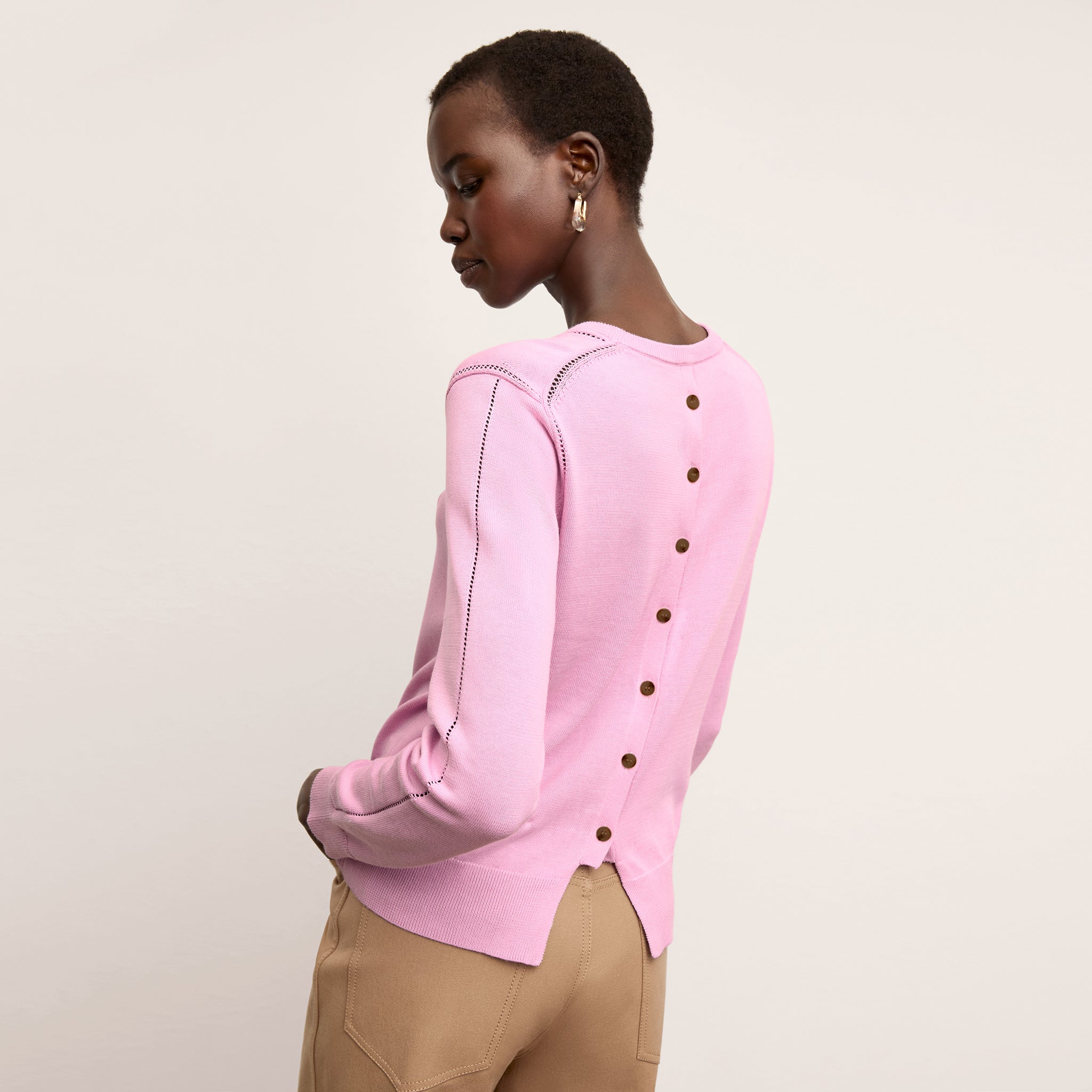 back image of a woman wearing the larissa sweater in taffy