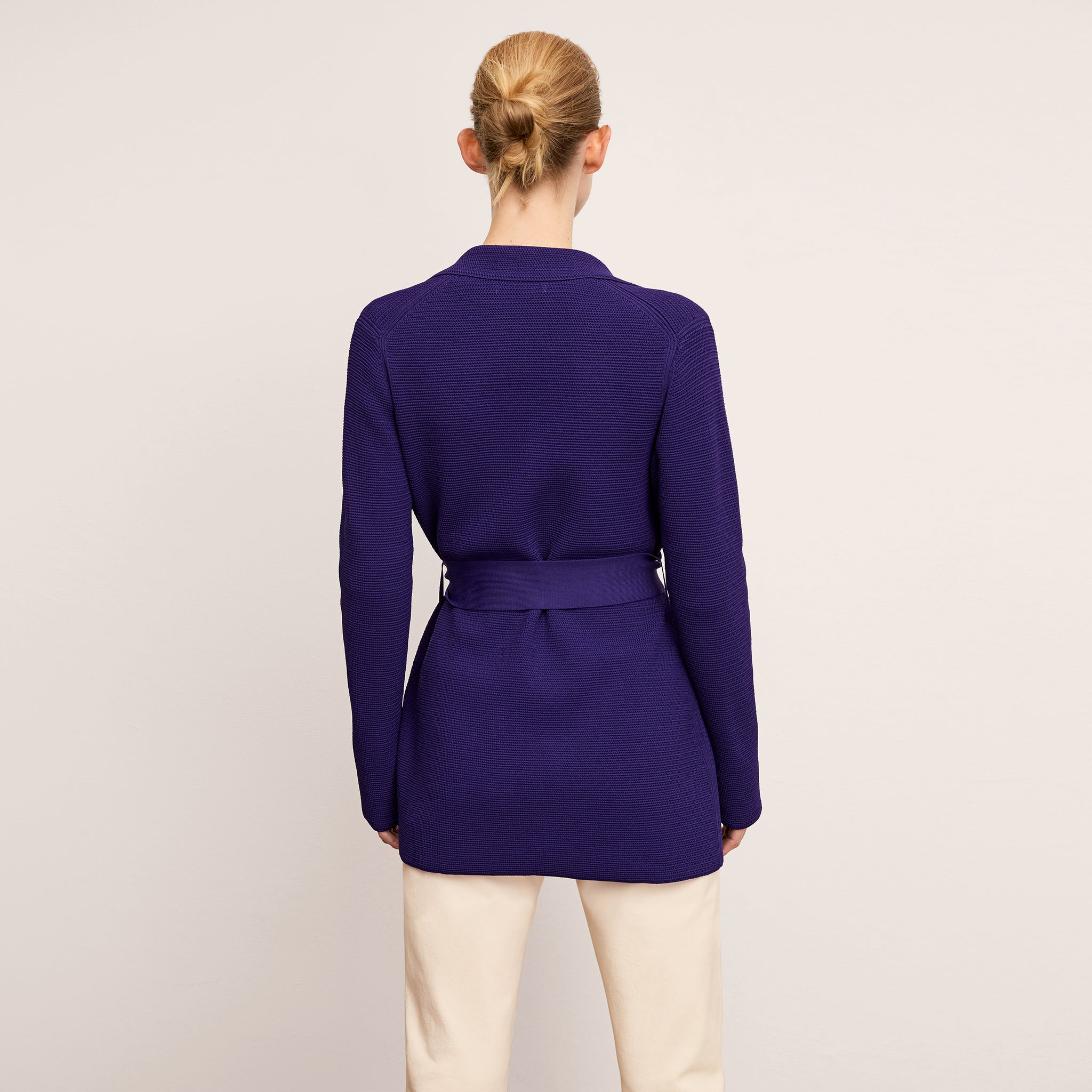 back image of a woman wearing the textured merritt jardigan in amethyst