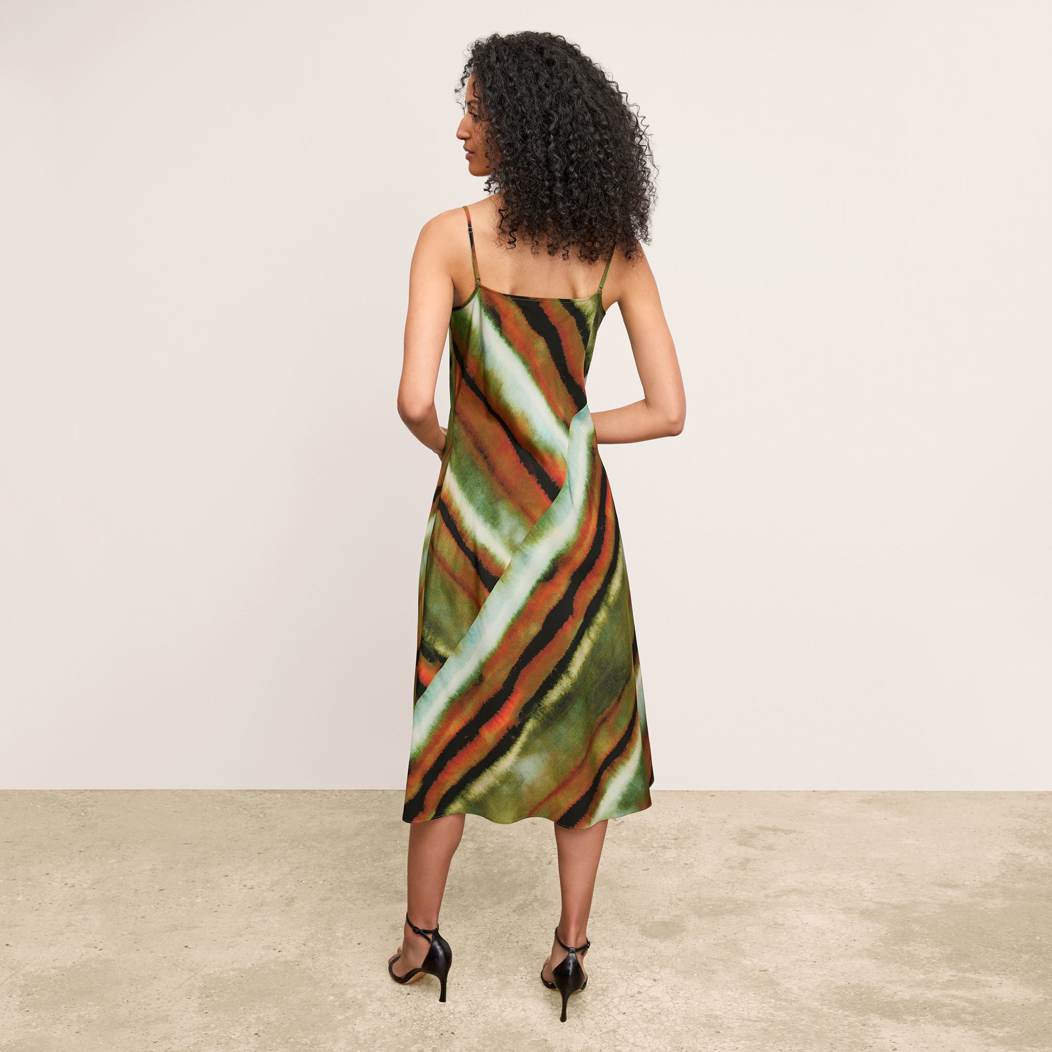 back image of a woman wearing the nene dress in faded print