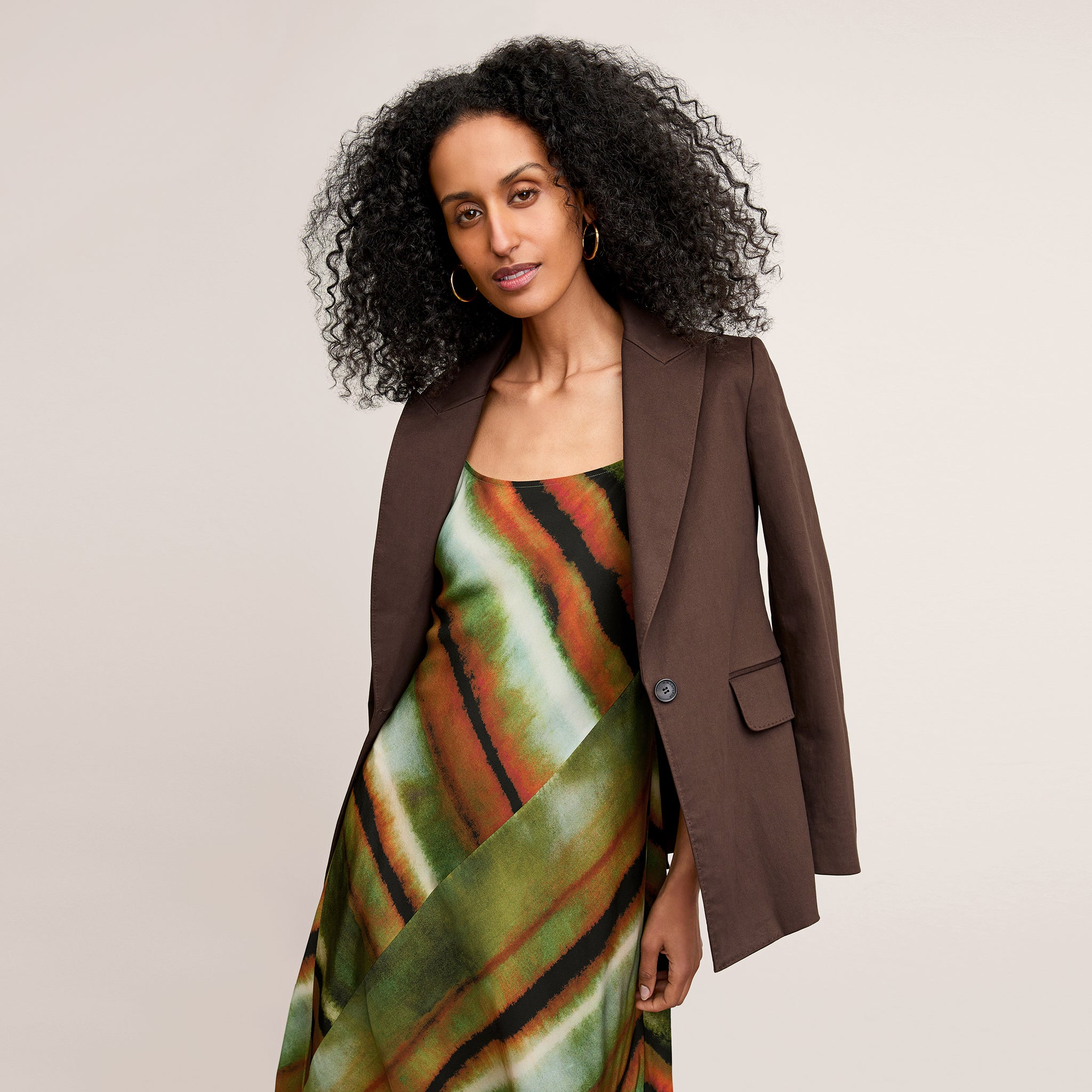 front image of a woman wearing the nene dress in faded print