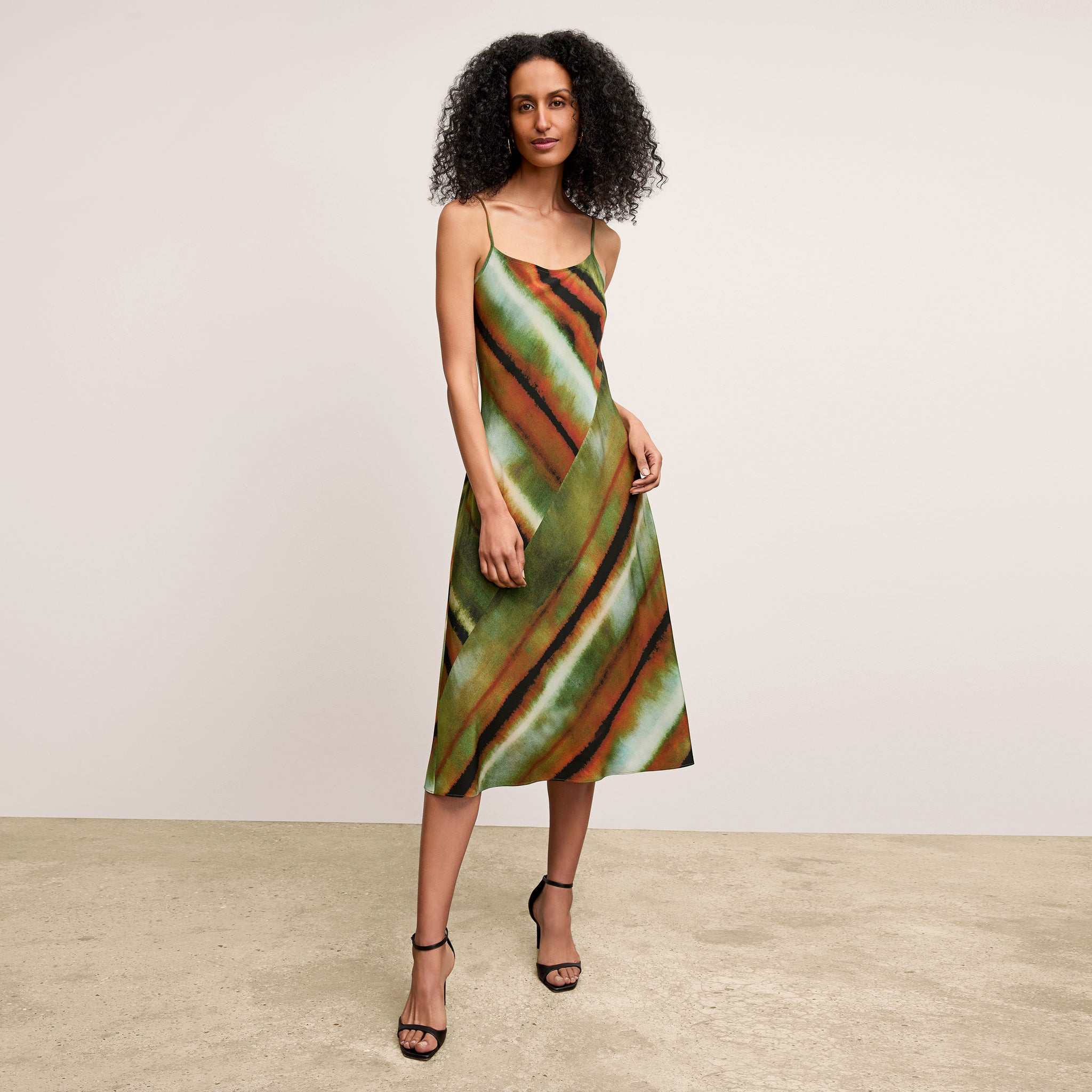 front image of a woman wearing the nene dress in faded print 