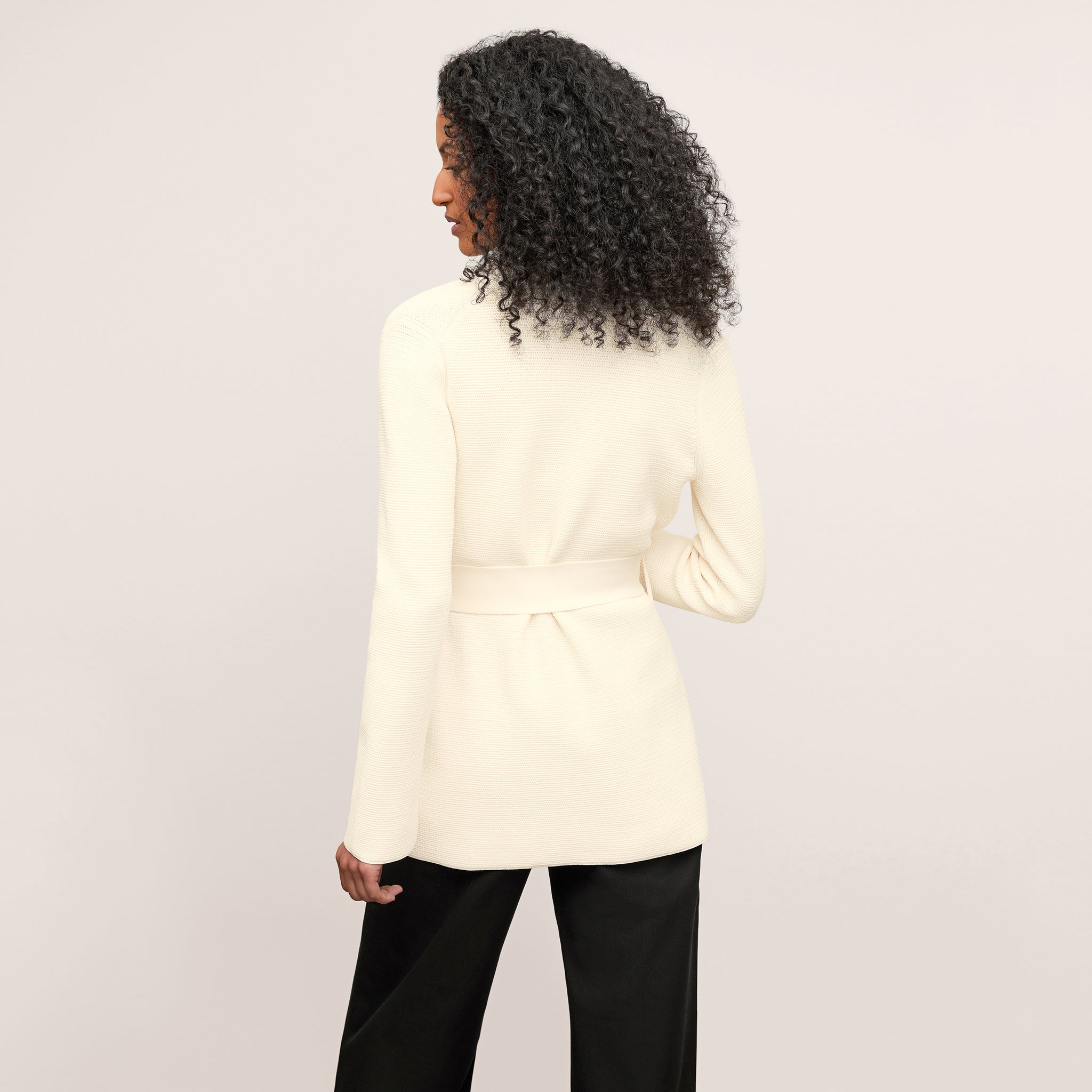 back image of a woman wearing the textured merritt jardigan in ivory