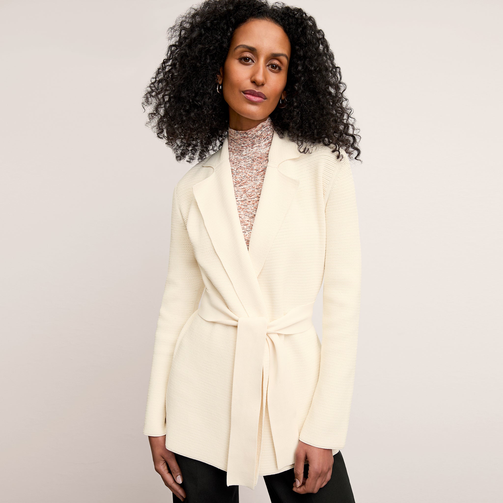 front image of a woman wearing the textured merritt jardigan in ivory  