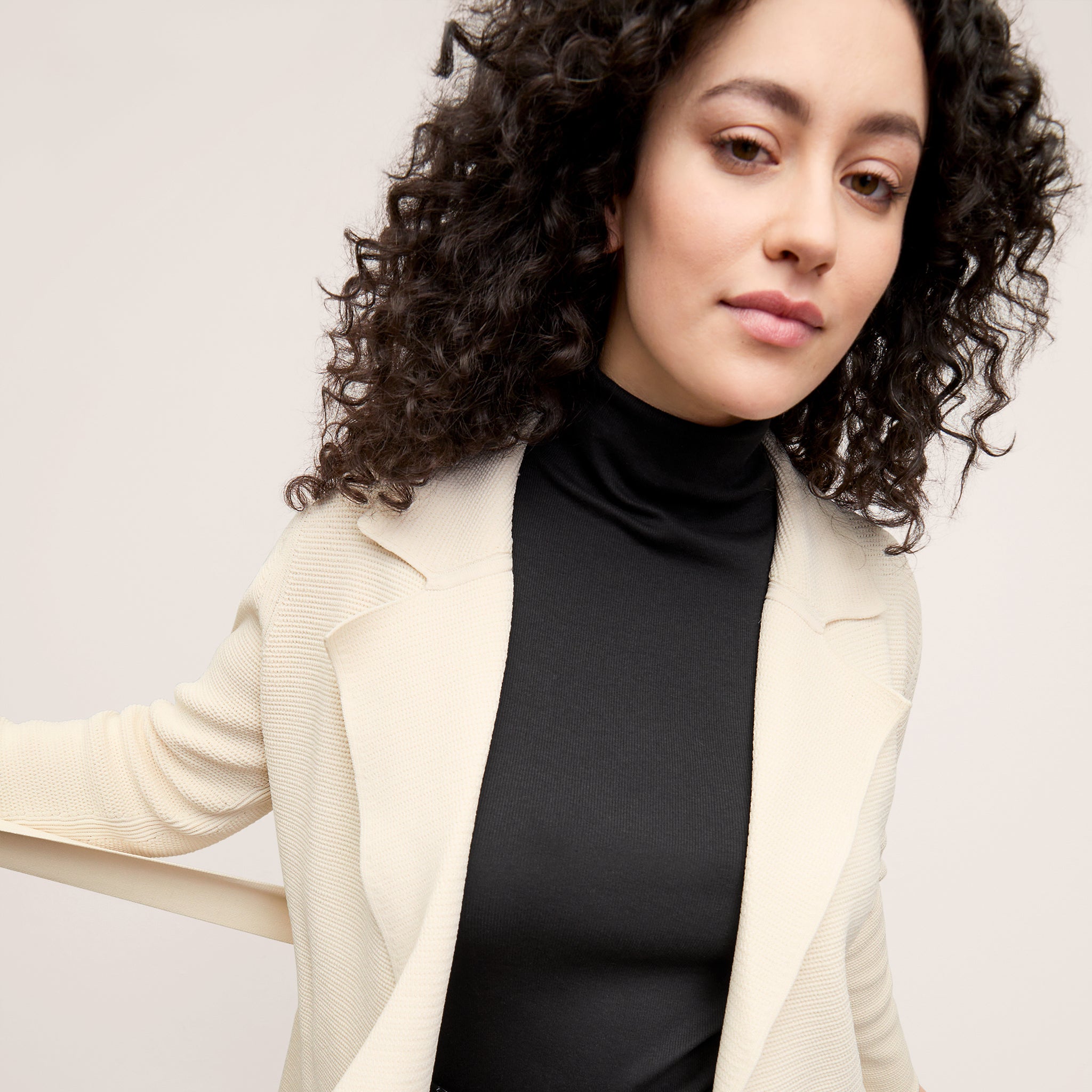 front image of a woman wearing the textured merritt jardigan in ivory